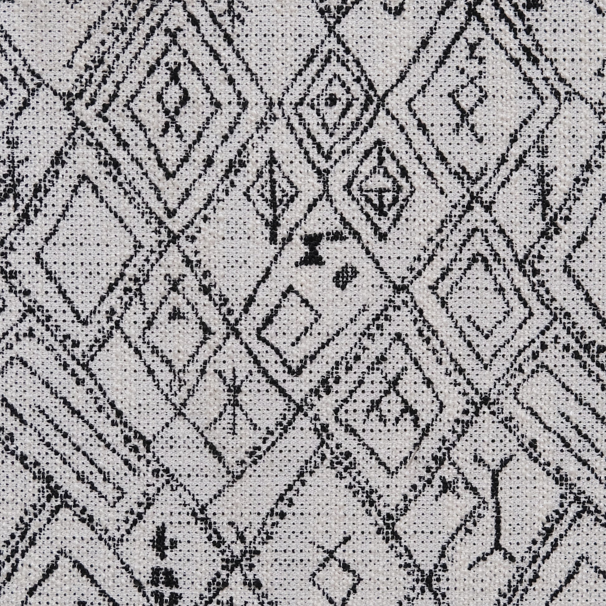 Black and white geometric diamond pattern on textured fabric