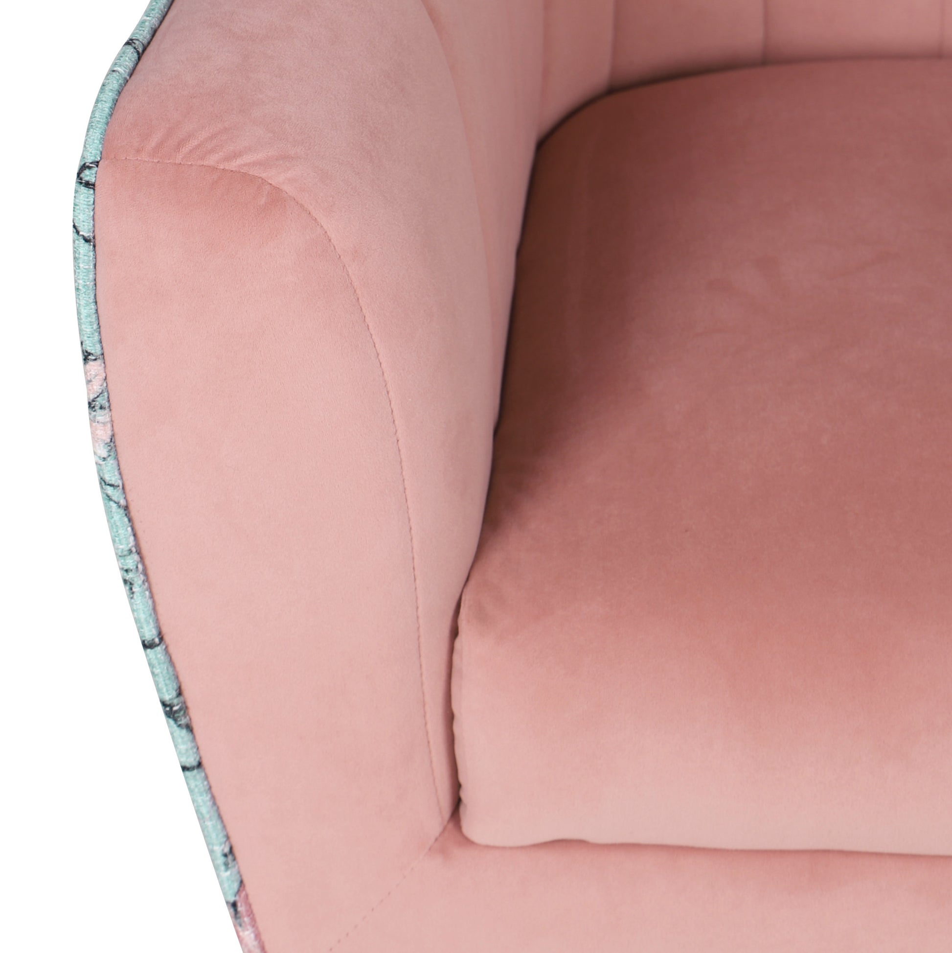 Closeup of a plush pink velvet armchair seat with subtle stitching details