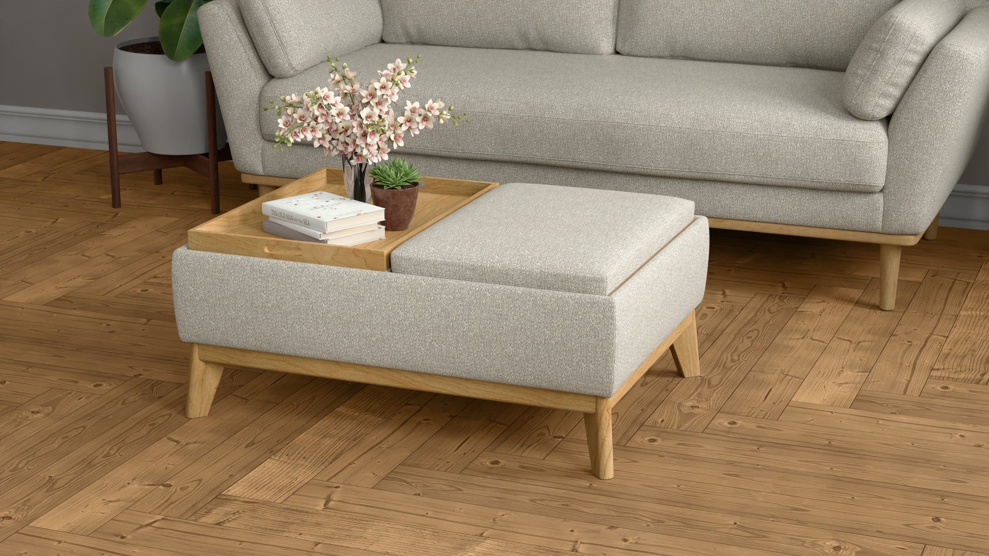 Light gray fabric ottoman with wooden legs and a wooden tray holding books