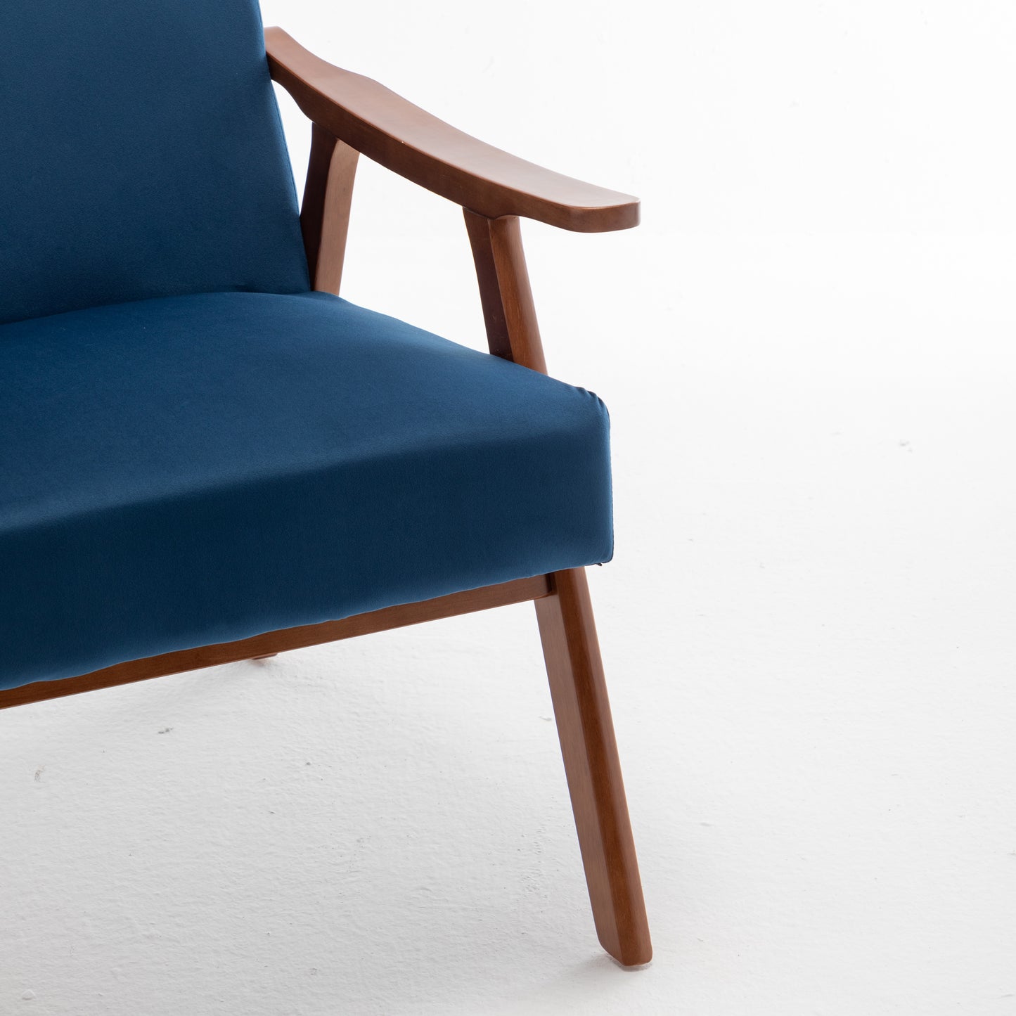Navy blue fabric armchair with curved wooden armrests and legs