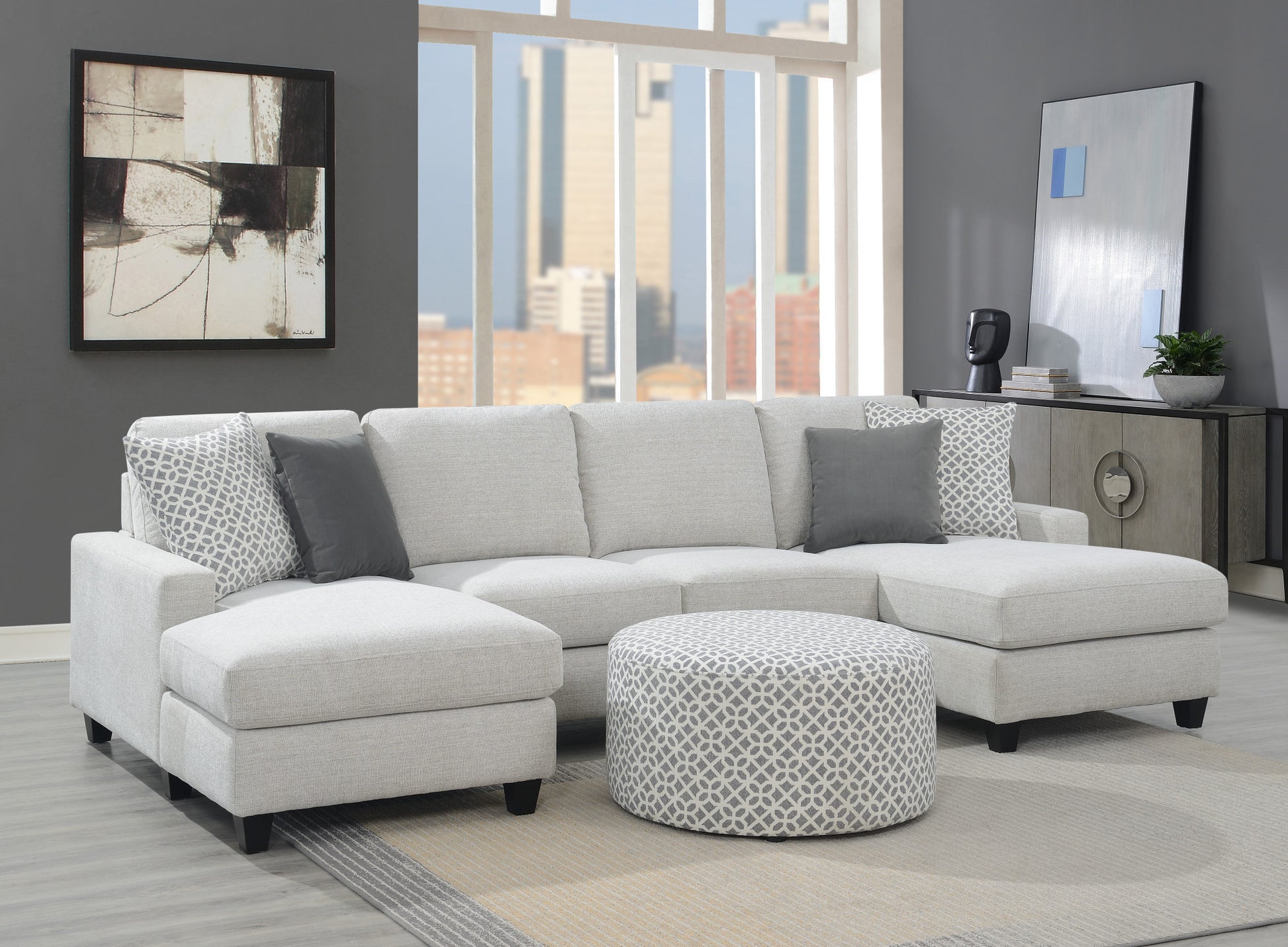 Light grey upholstered sectional sofa with chaise and patterned ottoman