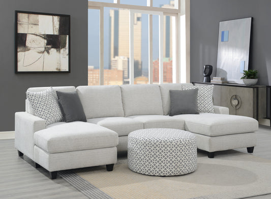 Light grey upholstered sectional sofa with chaise and patterned ottoman