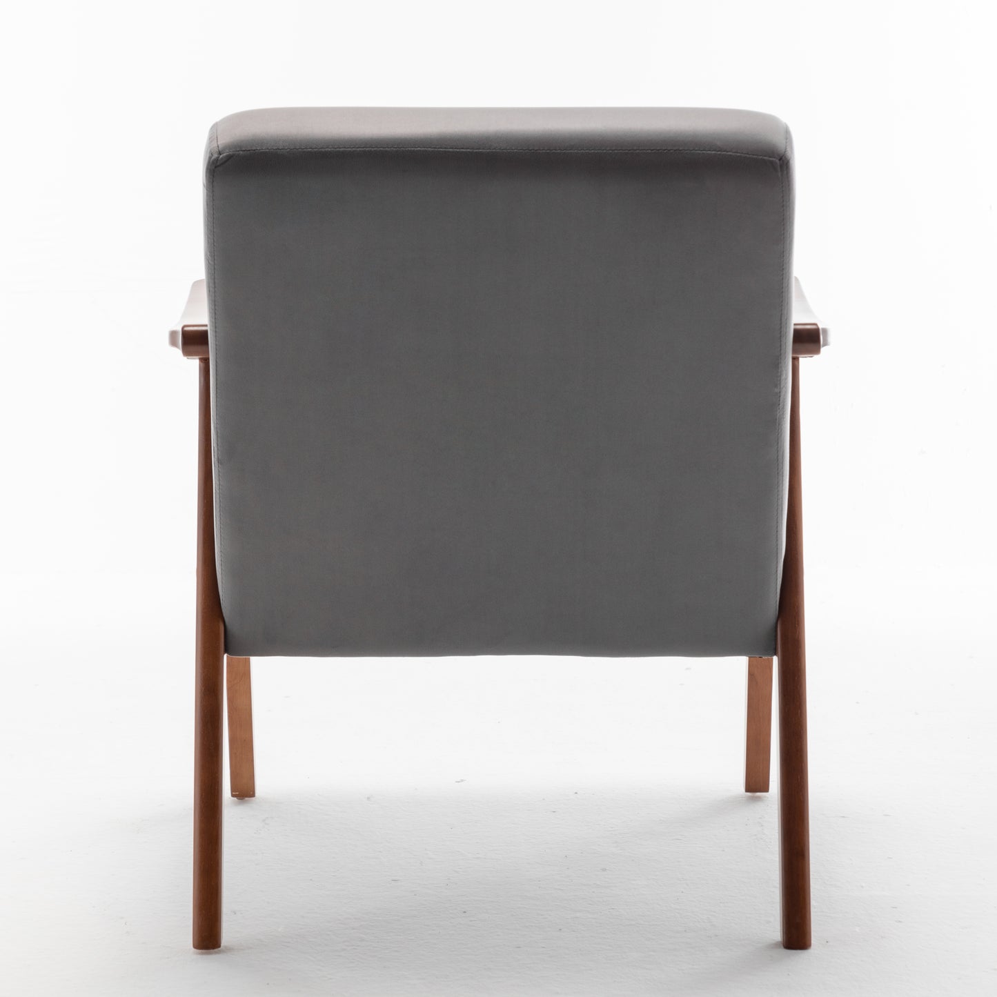 Back view of a grey upholstered midcentury modern armchair with wooden legs