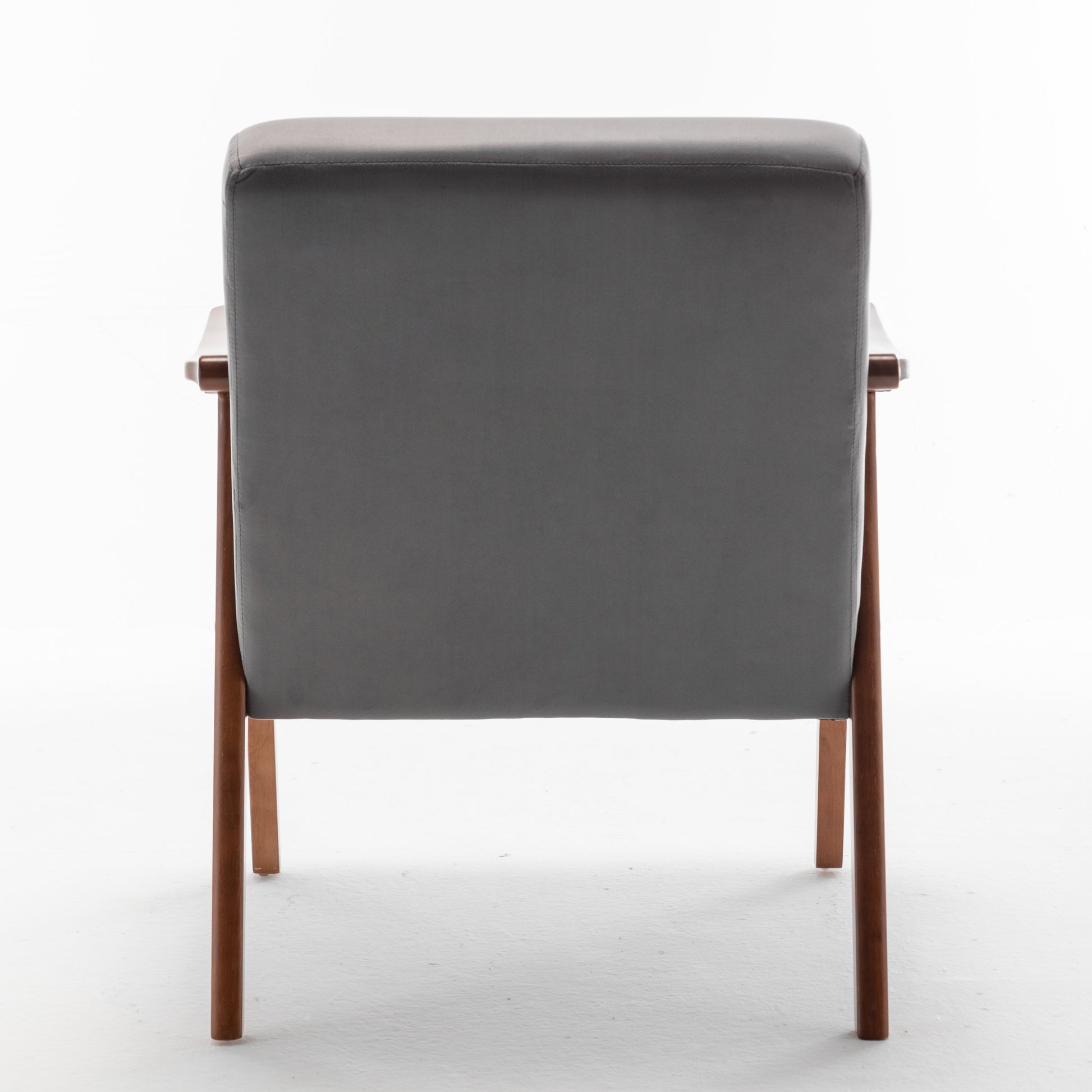 Back view of a grey upholstered midcentury modern armchair with wooden legs