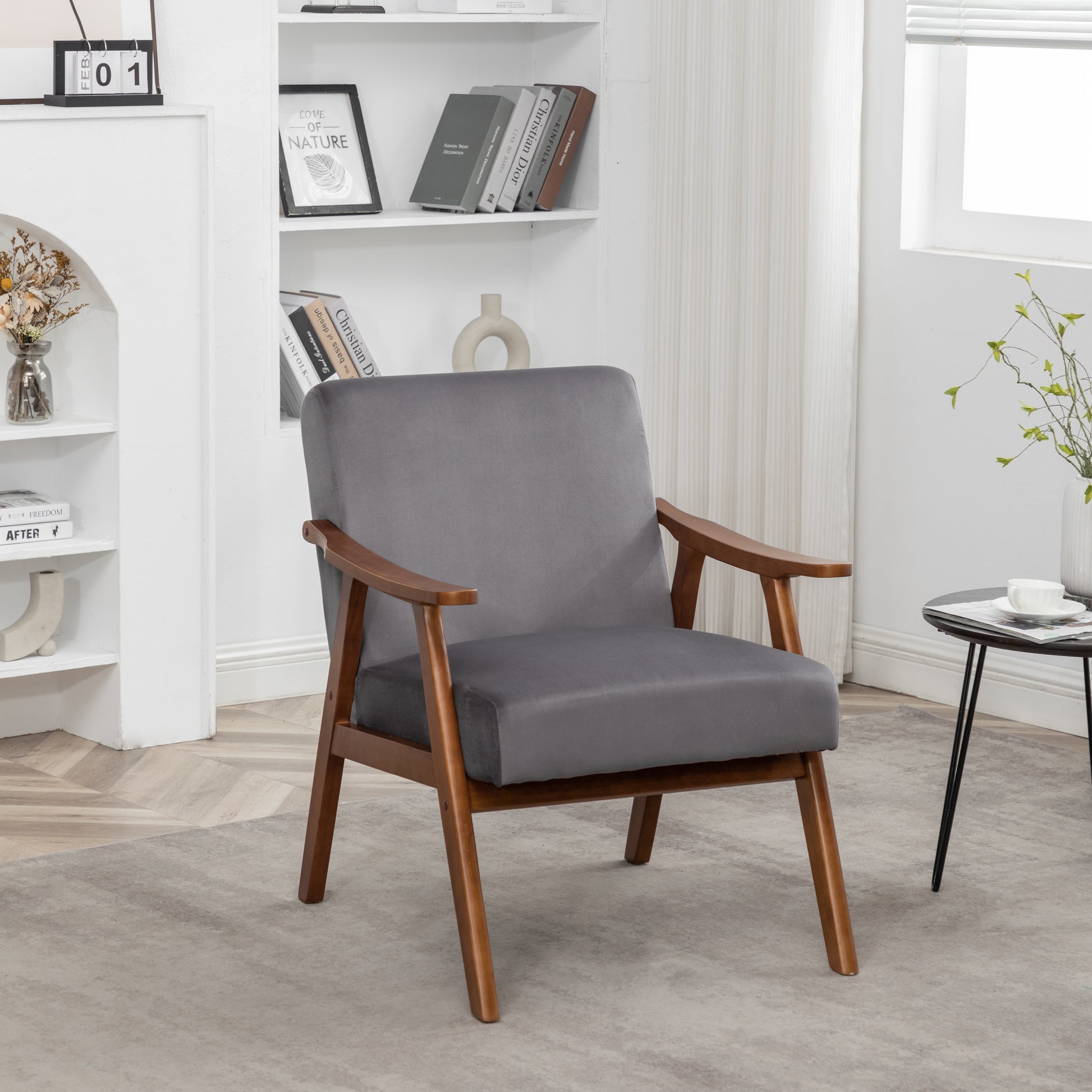 Midcentury modern grey velvet armchair with warm wooden frame and arms perfect for a living room accent chair