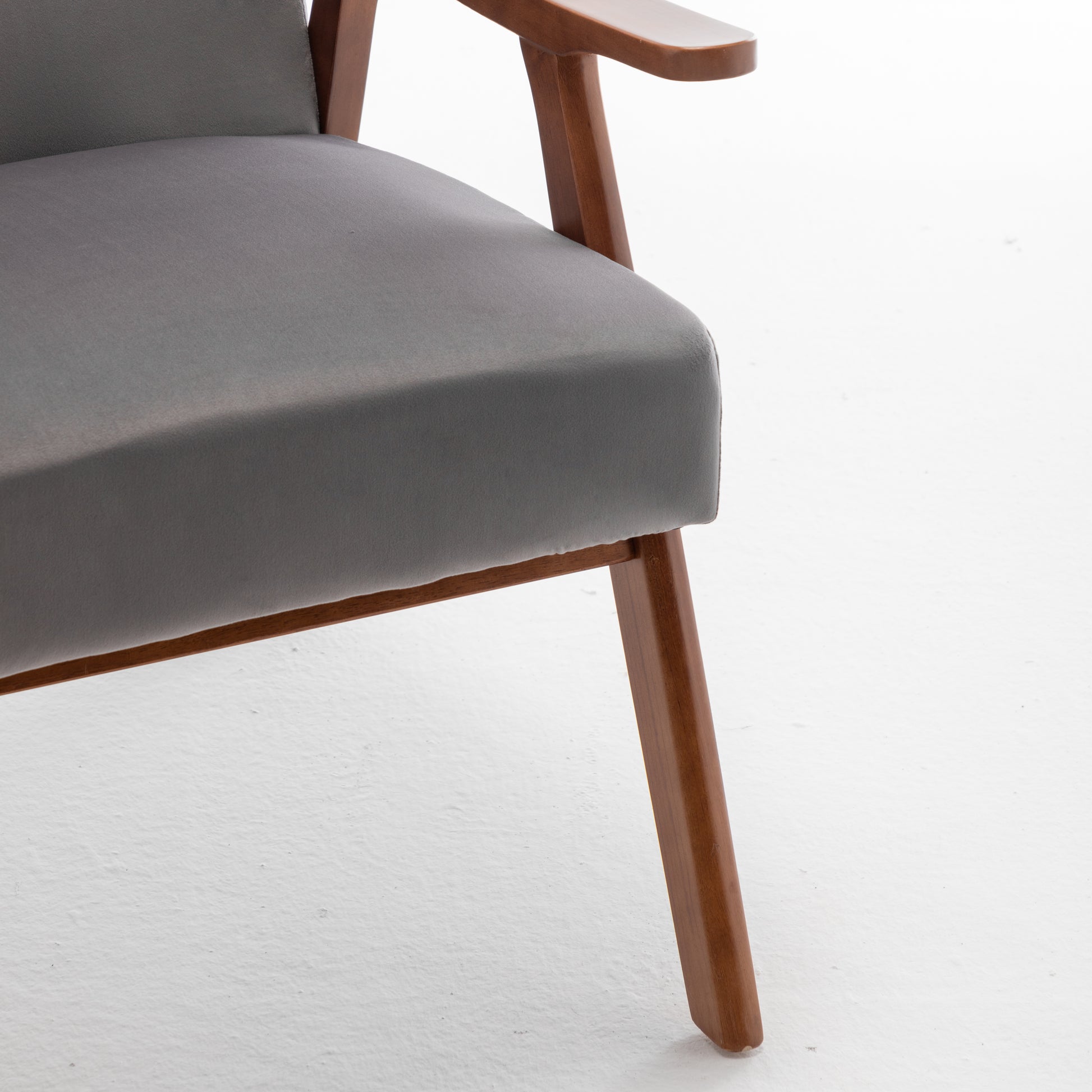 Closeup of a grey fabric armchair seat with wooden frame
