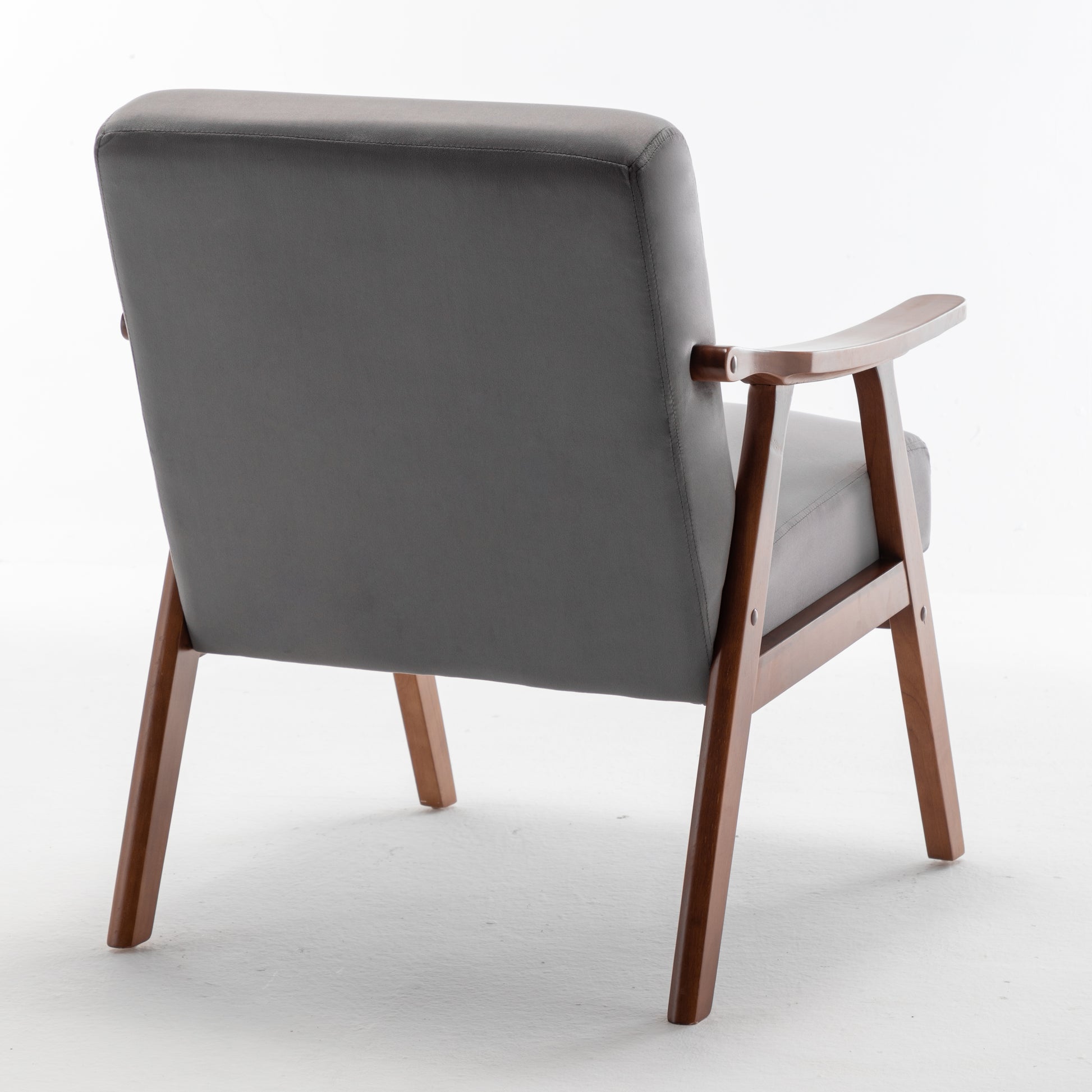 Back view of a grey upholstered armchair with wooden legs