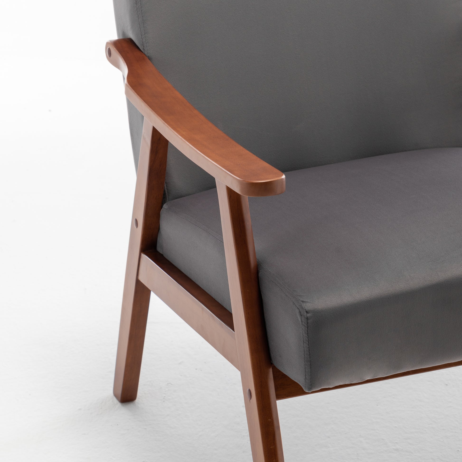 Modern grey upholstered armchair with natural wood frame arms
