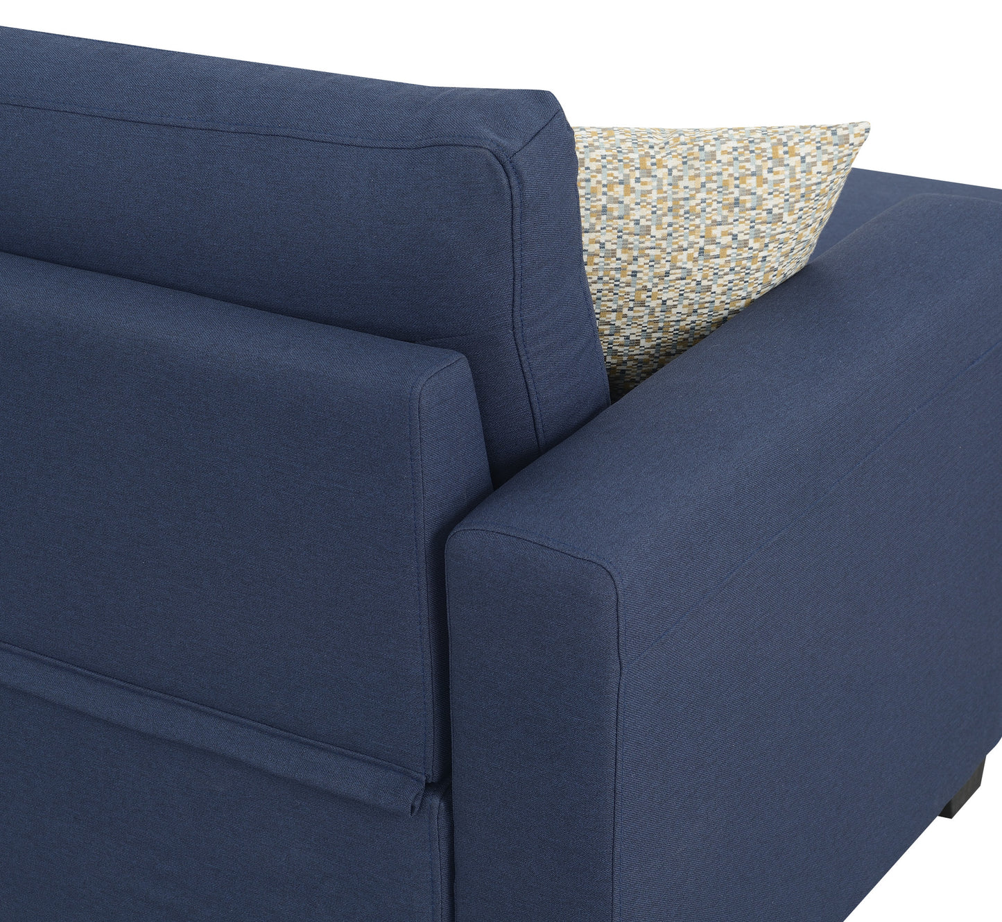 Closeup of a navy blue upholstered sofa arm with a textured throw pillow