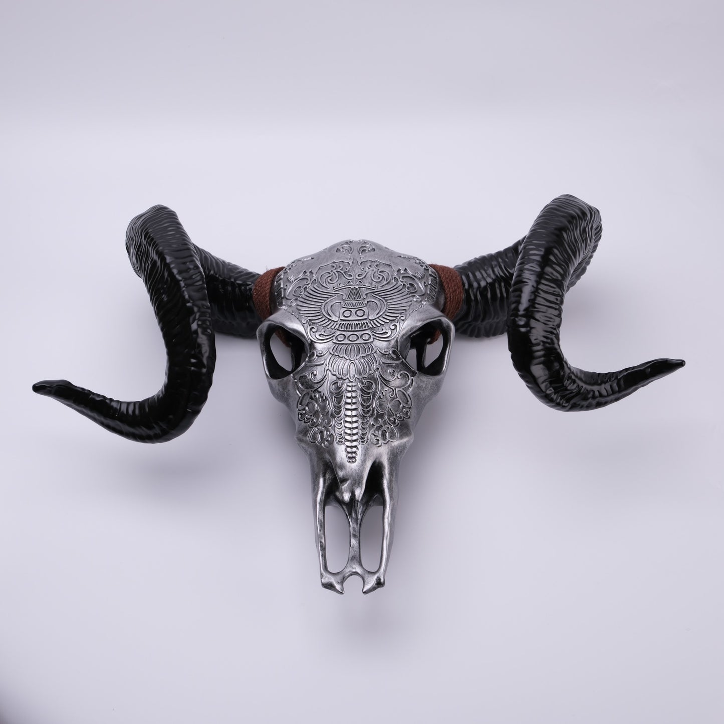 Silver ram skull wall decor with intricate tribal etchings and black horns