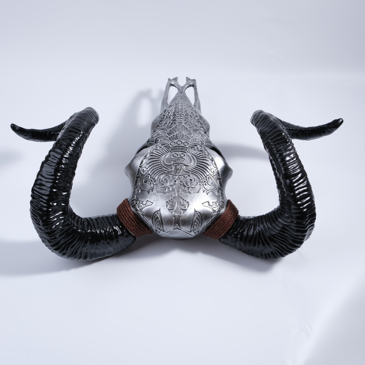Silver ornate bull skull wall decor with textured black horns