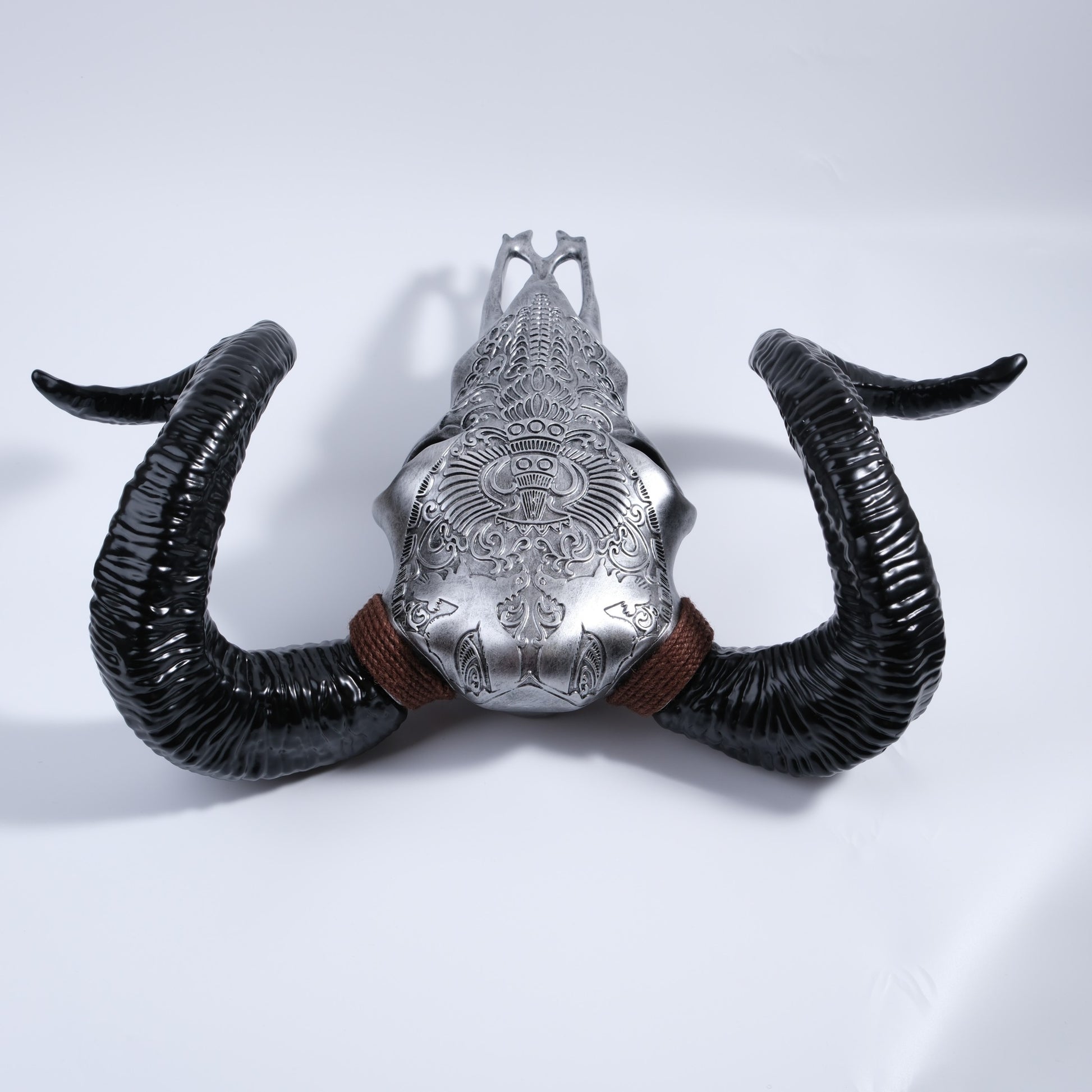 Silver ornate bull skull wall decor with textured black horns