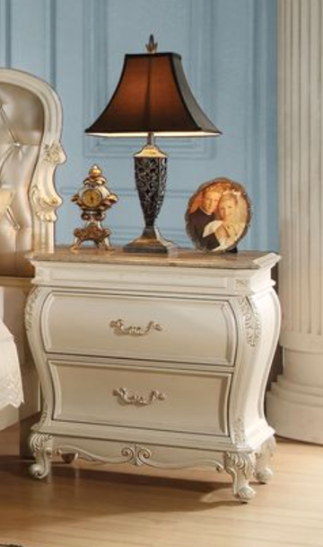 Cream upholstered nightstand with ornate gold hardware and marble top