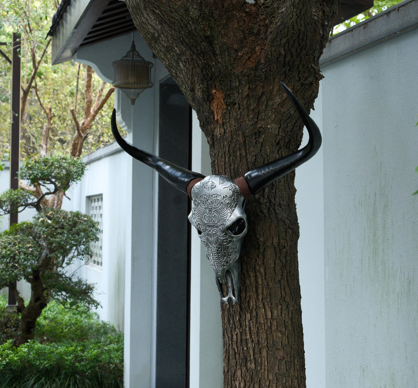 Decorative bull skull wall art with intricate silver detailing and black horns