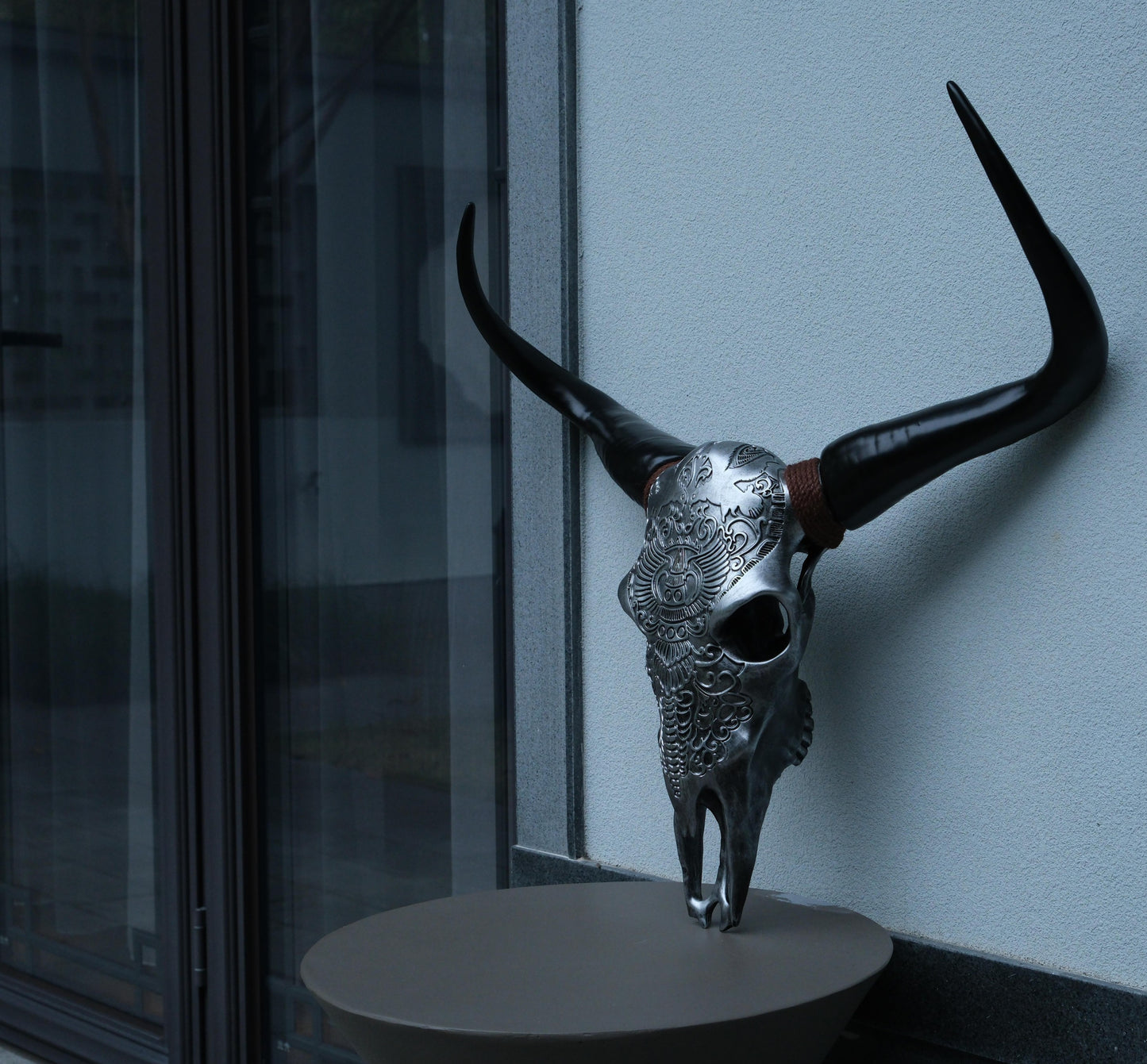 Silver steer skull wall art with black horns and intricate carvings