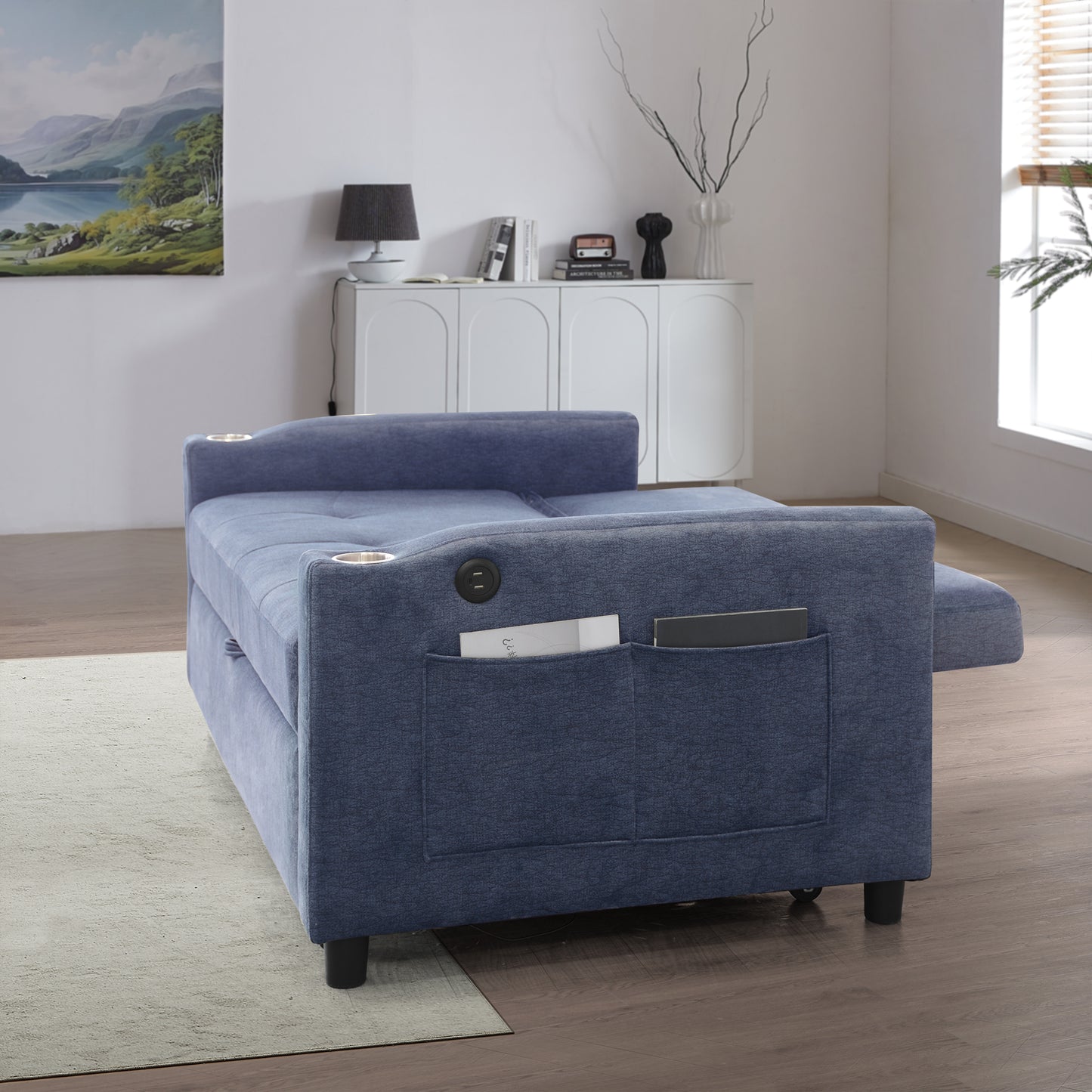 Navy blue sofa bed with builtin cup holders and storage pockets