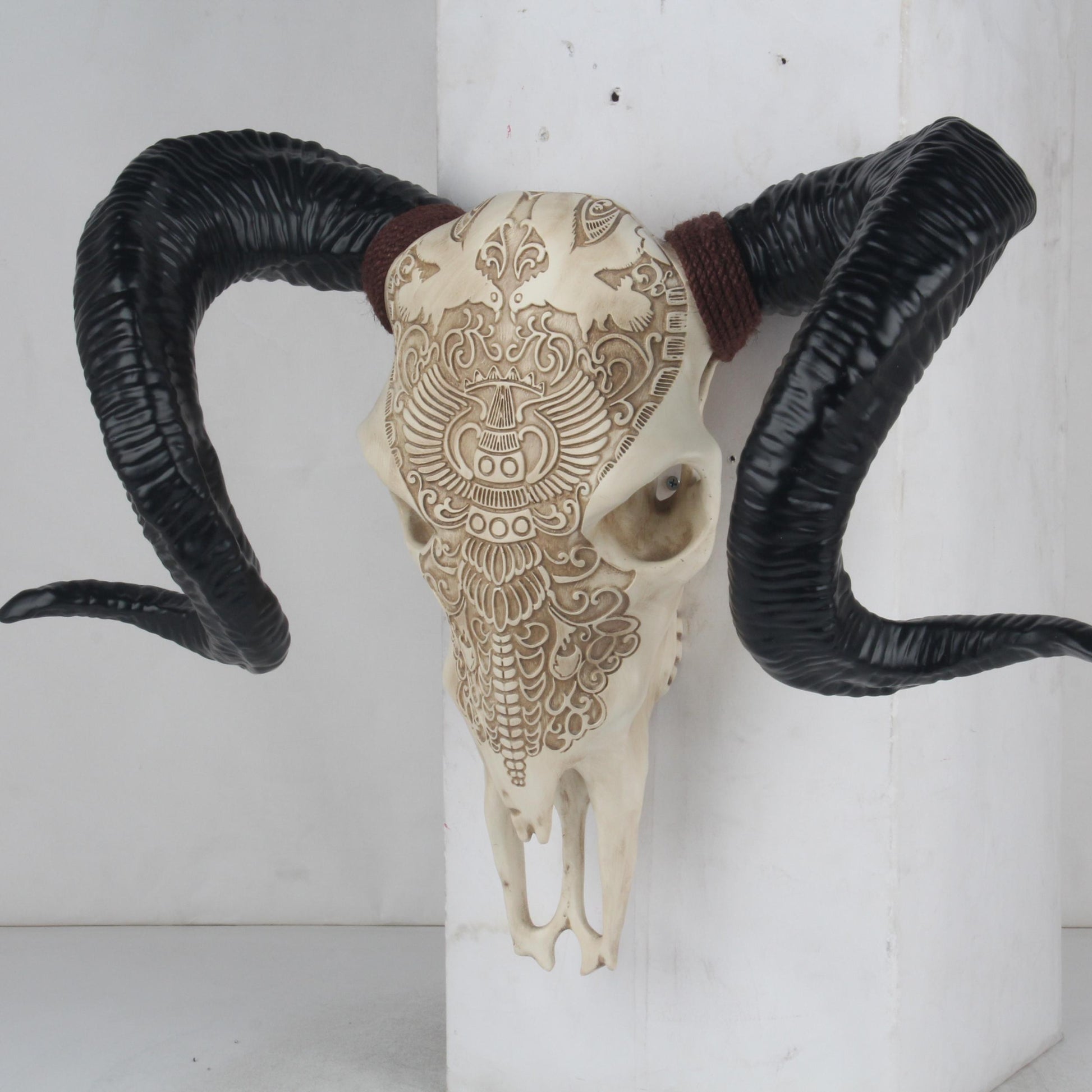 Ornate carved skull with large black ram horns