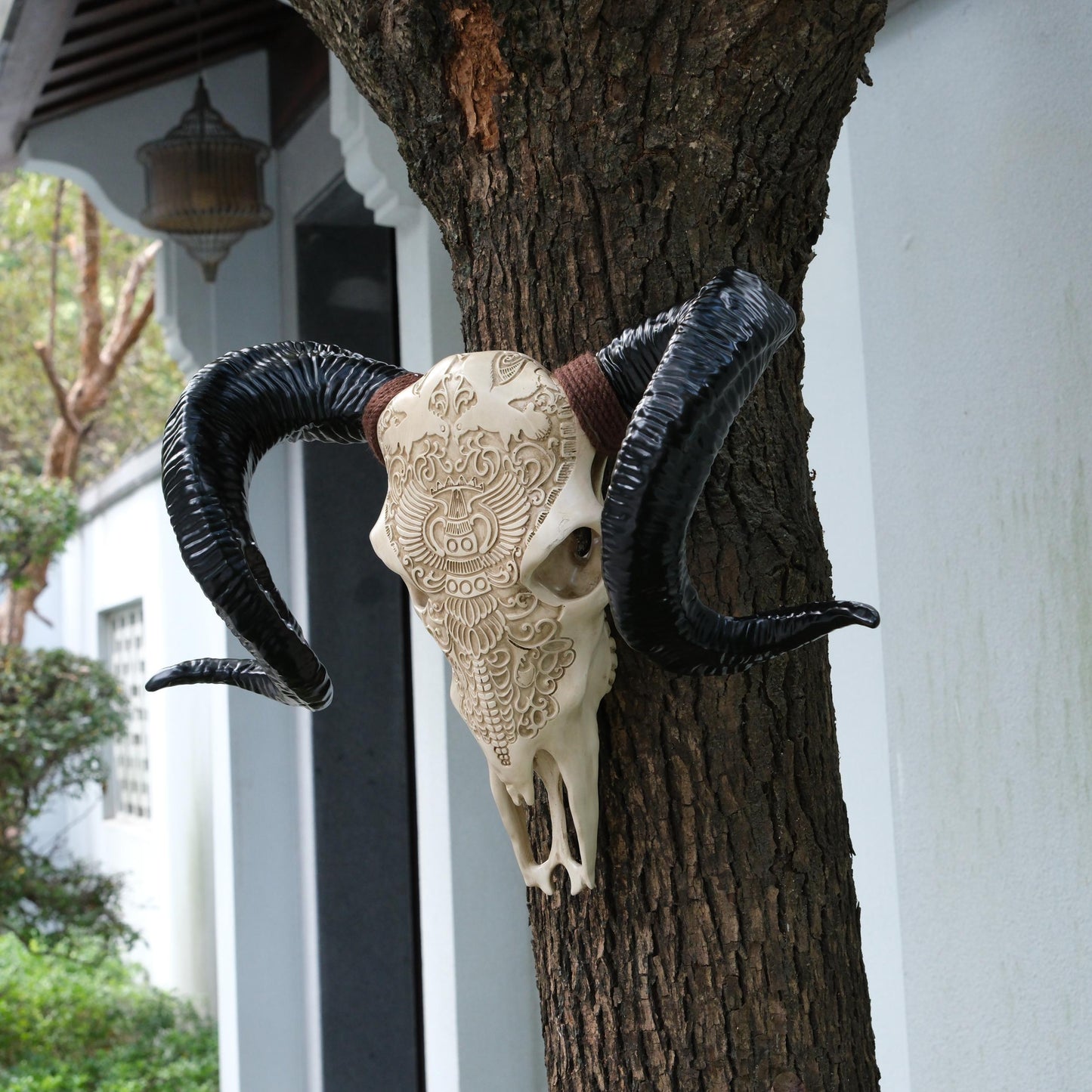 Ornate ram skull decor with detailed carvings and black curved horns perfect for gothicthemed spaces