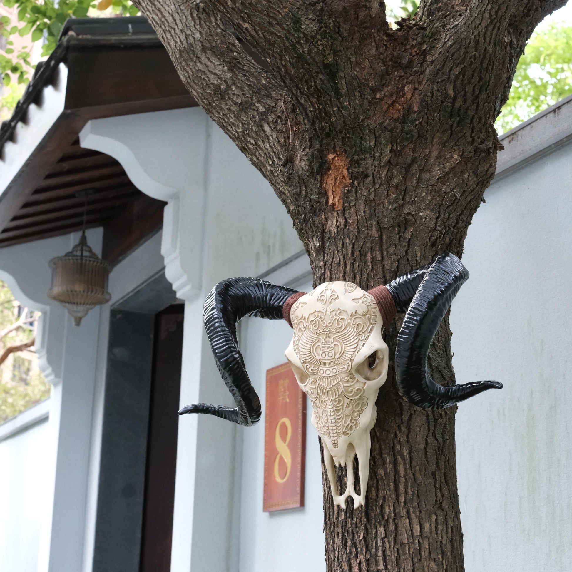 ornate carved ram skull with large black horns