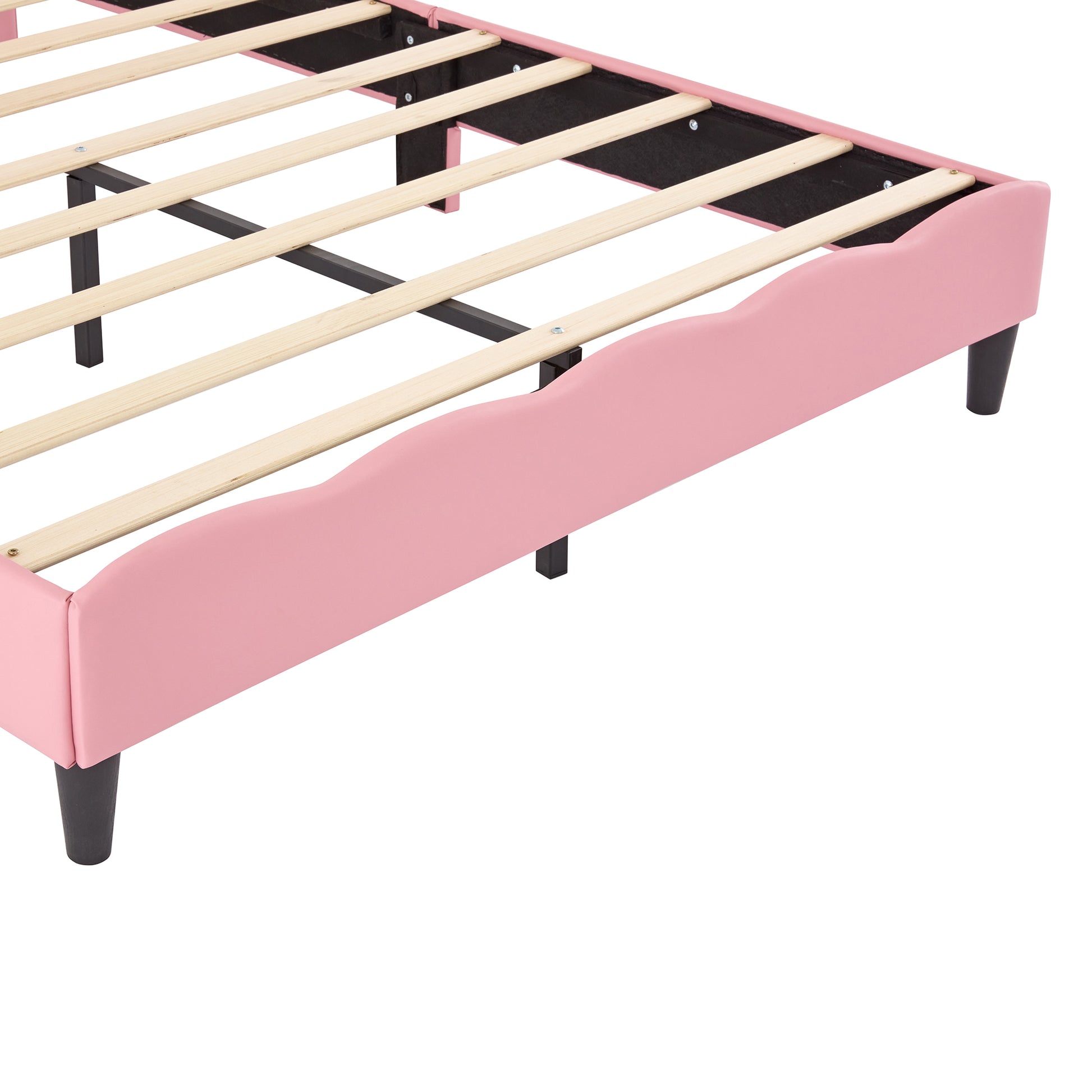 Pink upholstered twin bed frame with scalloped edges and wooden slats