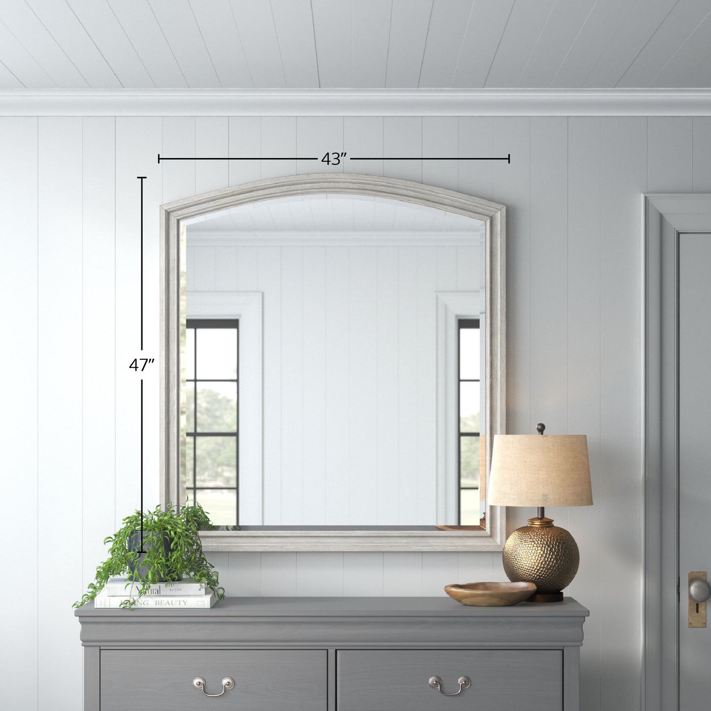 Arched grey wood mirror  inches wide reflecting a modern interior