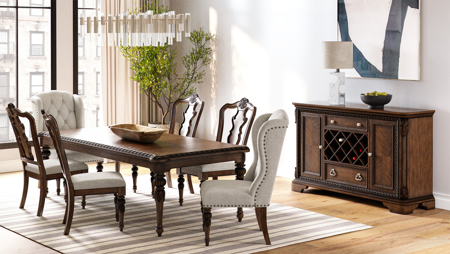 Dark wood dining table with carved legs and upholstered chairs