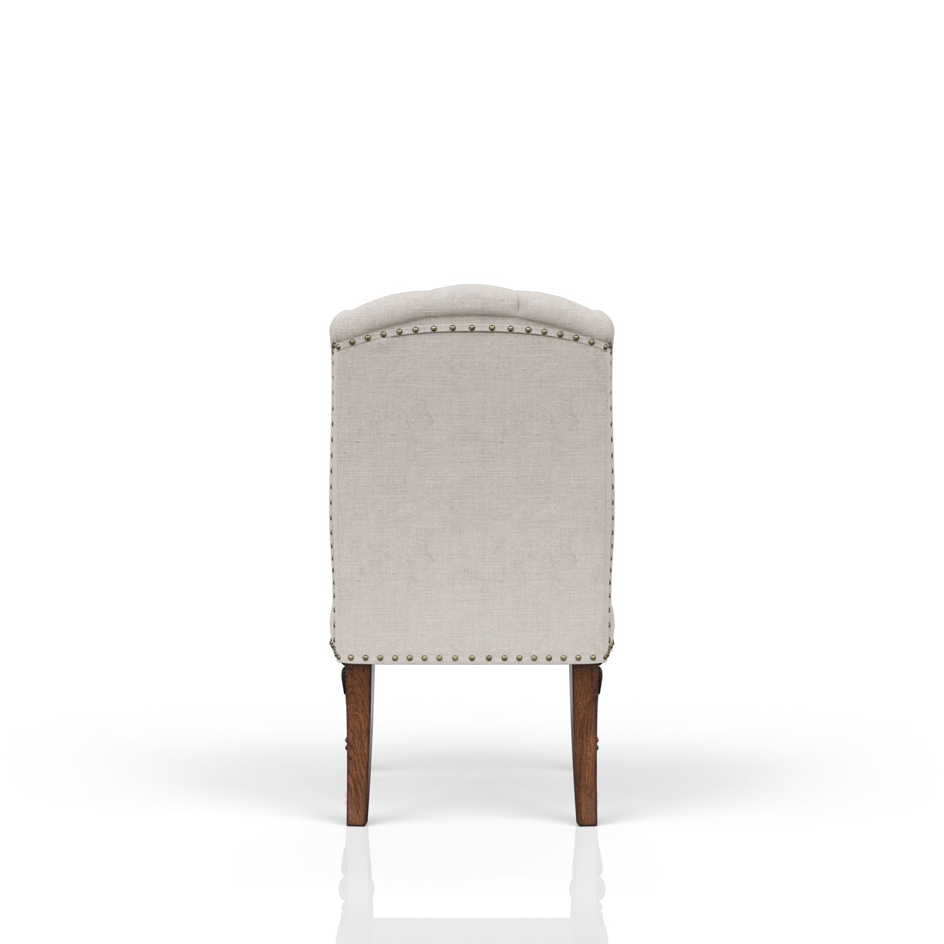 Tufted linen accent chair with brass nailhead trim and carved wooden legs