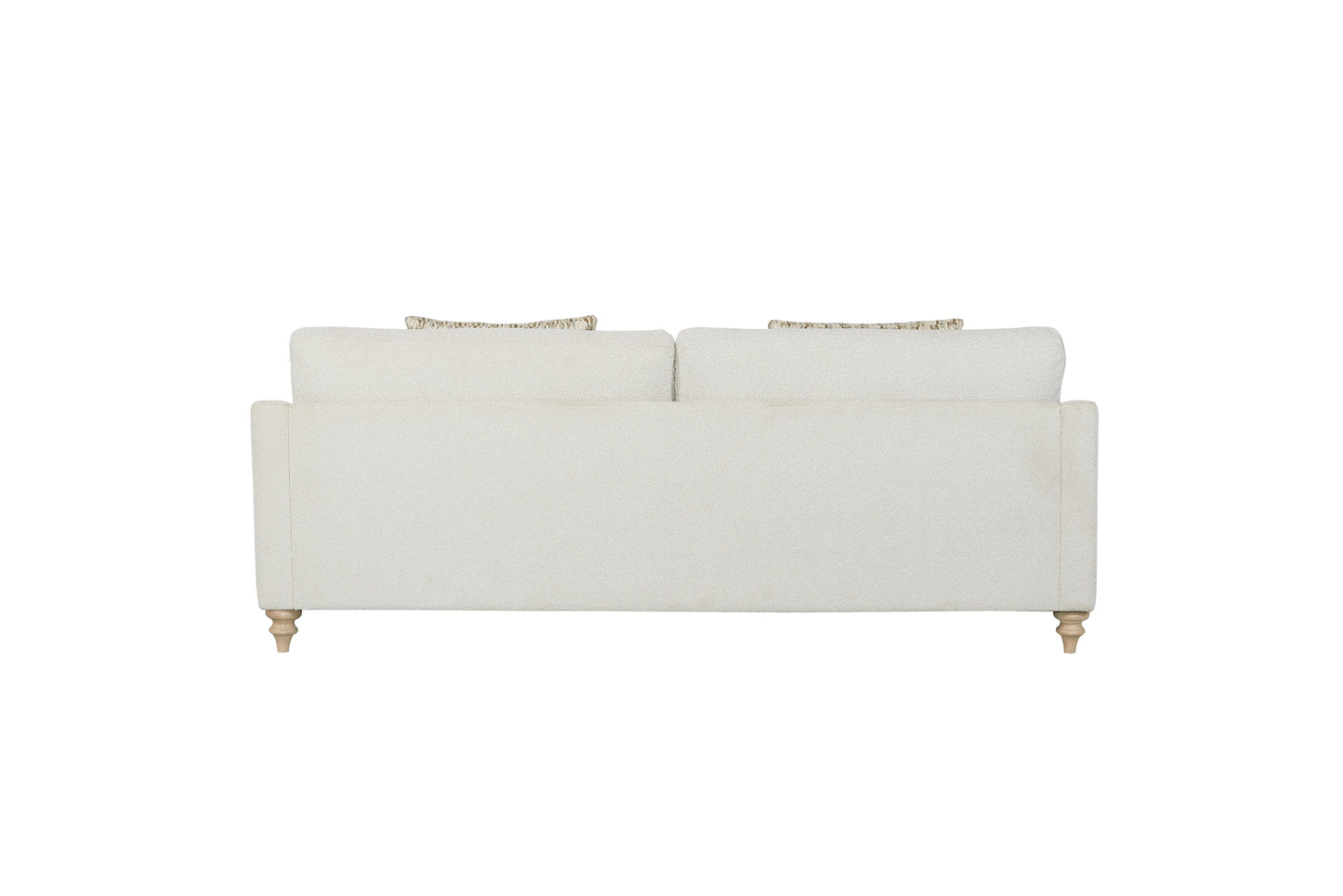 Cream textured upholstered sofa with decorative throw pillows and carved wooden legs