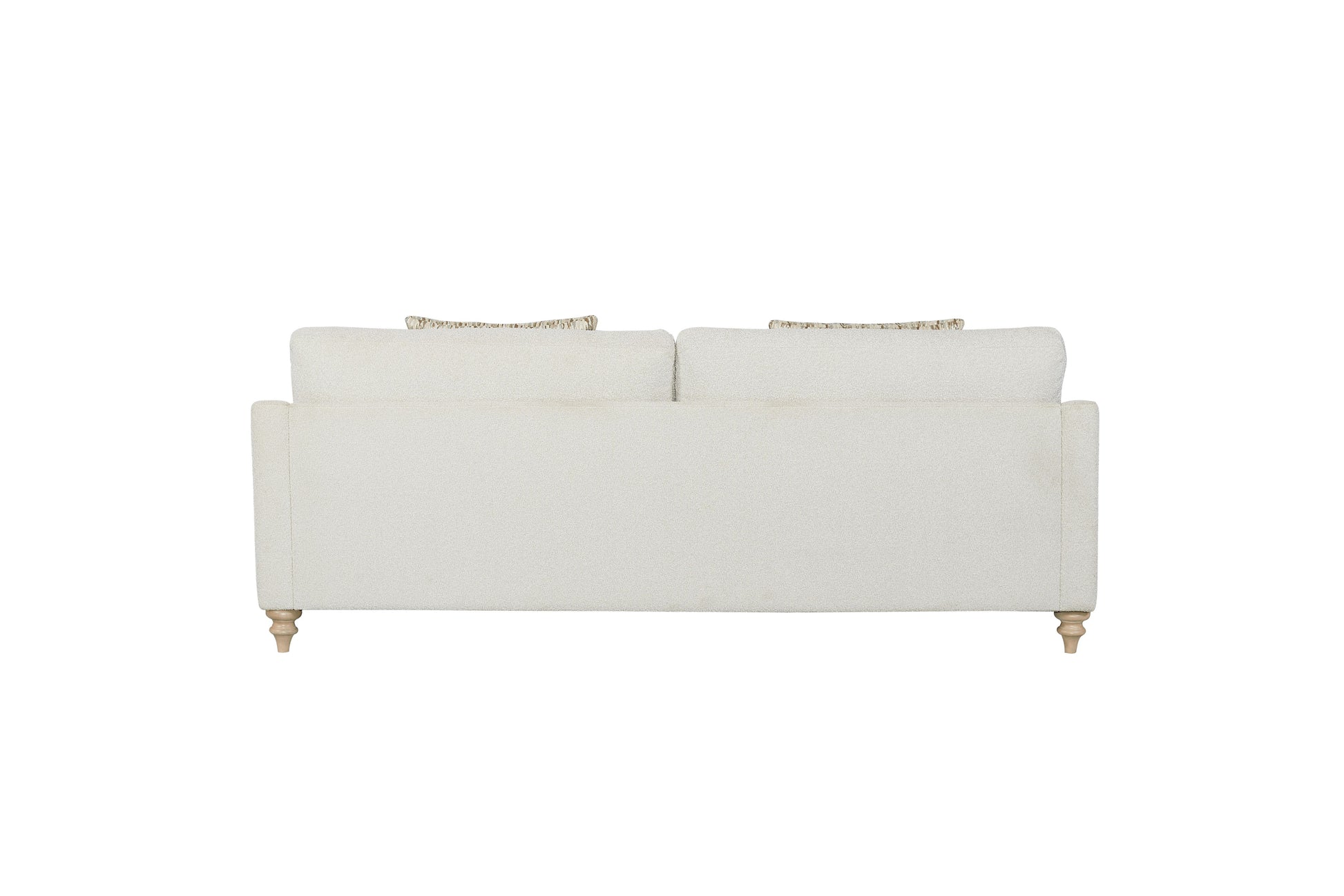 Cream textured upholstered sofa with decorative throw pillows and carved wooden legs