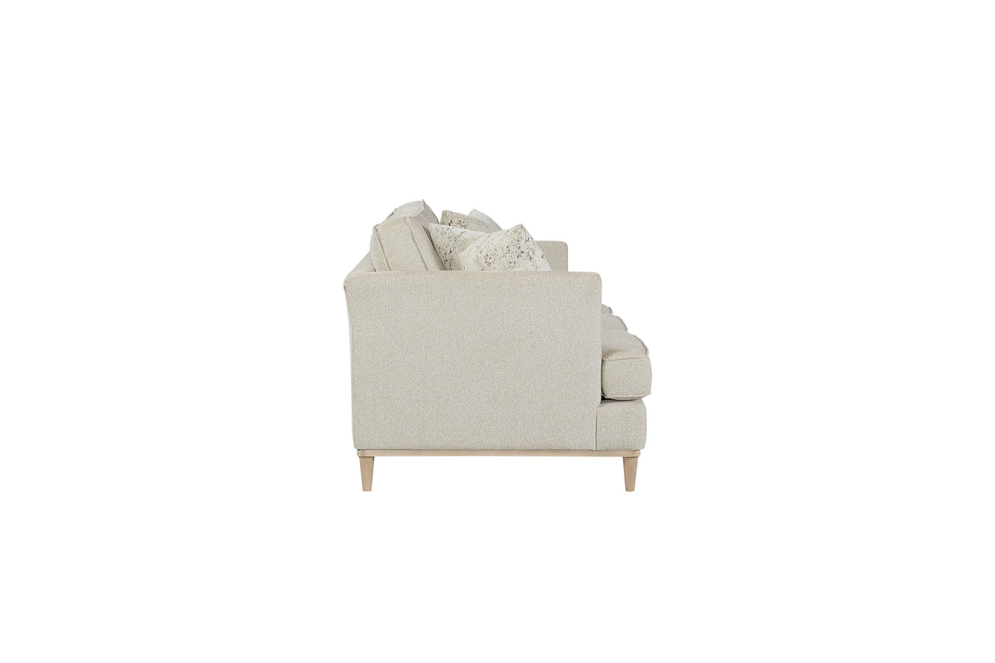 Side view of a light beige fabric sofa with plush cushions and wooden legs