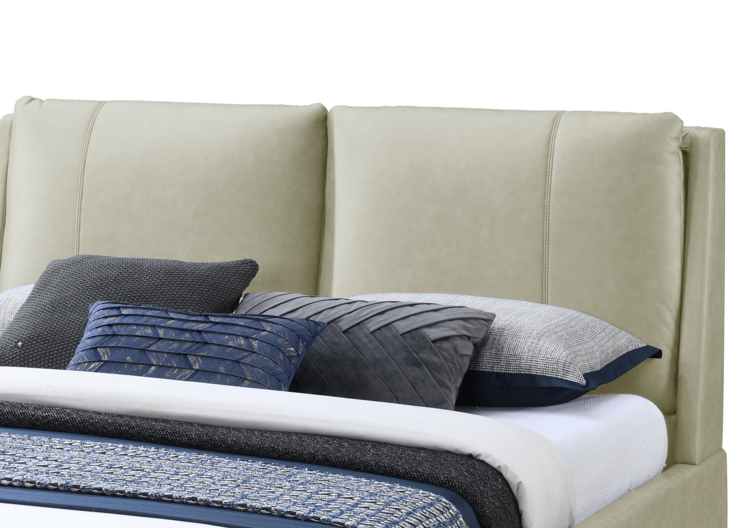 Cream leather tufted headboard with decorative pillows and bedding