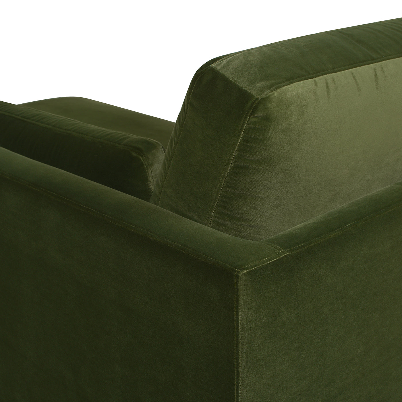 Deep green velvet sofa detail with plush cushions