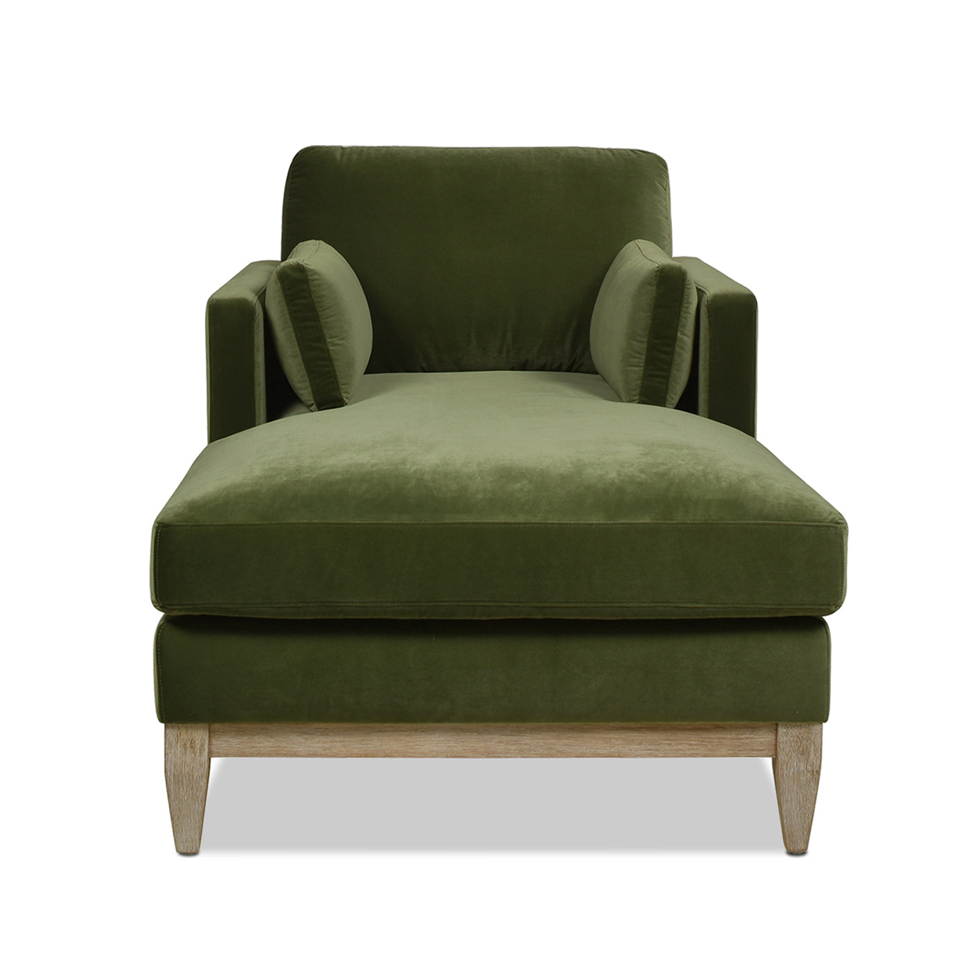 Plush green velvet chaise lounge with tapered wooden legs and two accent pillows