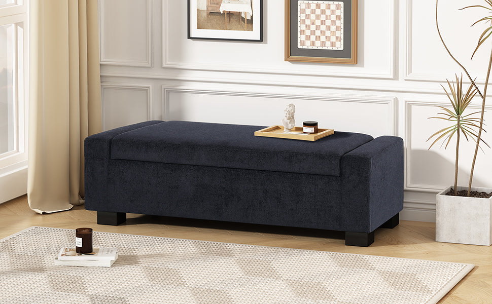 Dark navy upholstered storage ottoman with wooden legs