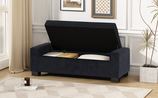 Dark navy upholstered storage bench with lid open showing pillows inside