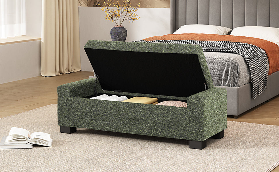 Green fabric storage bench with open lid showing stored items