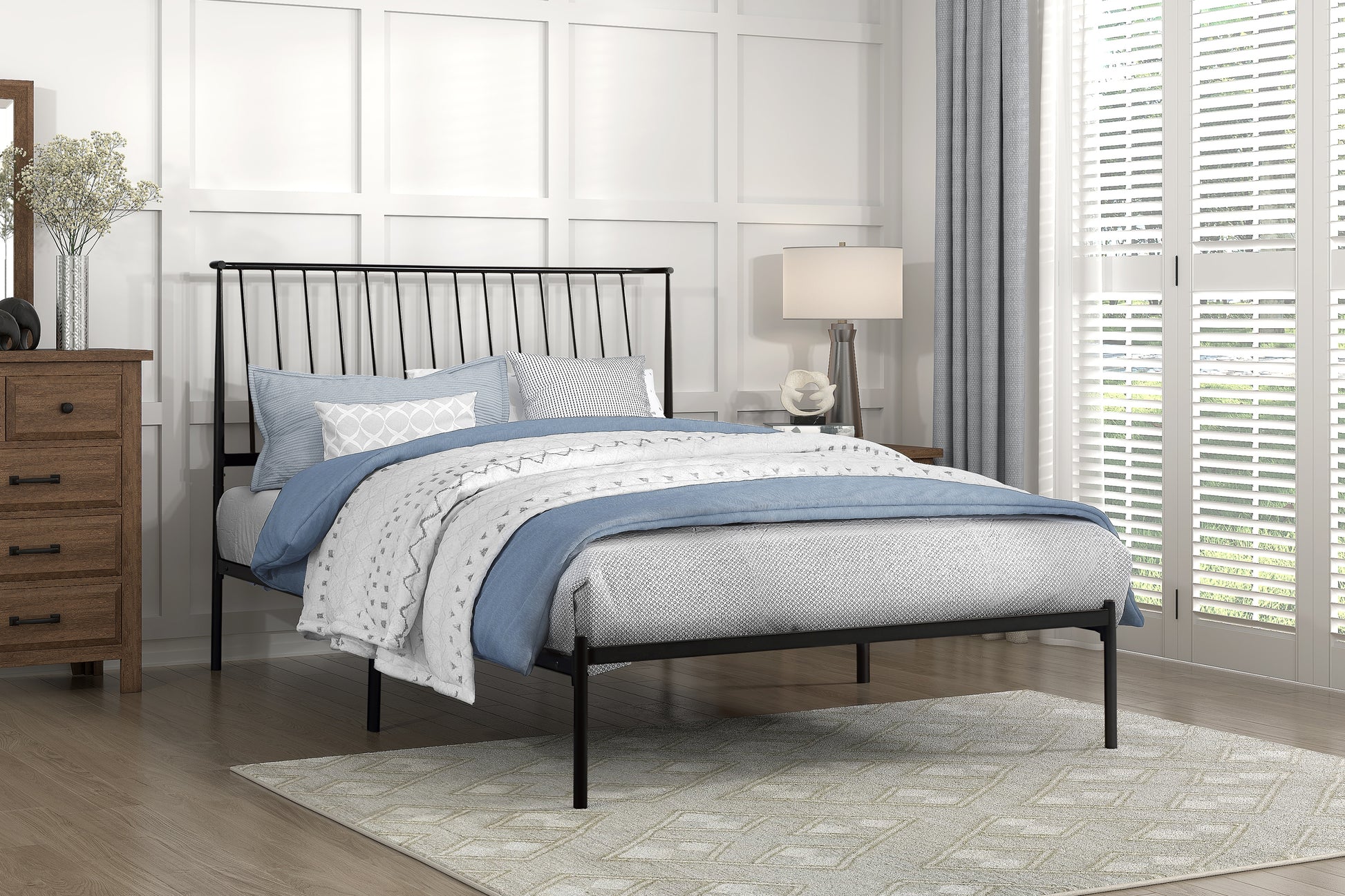 Black metal bed frame with slatted headboard and blue bedding