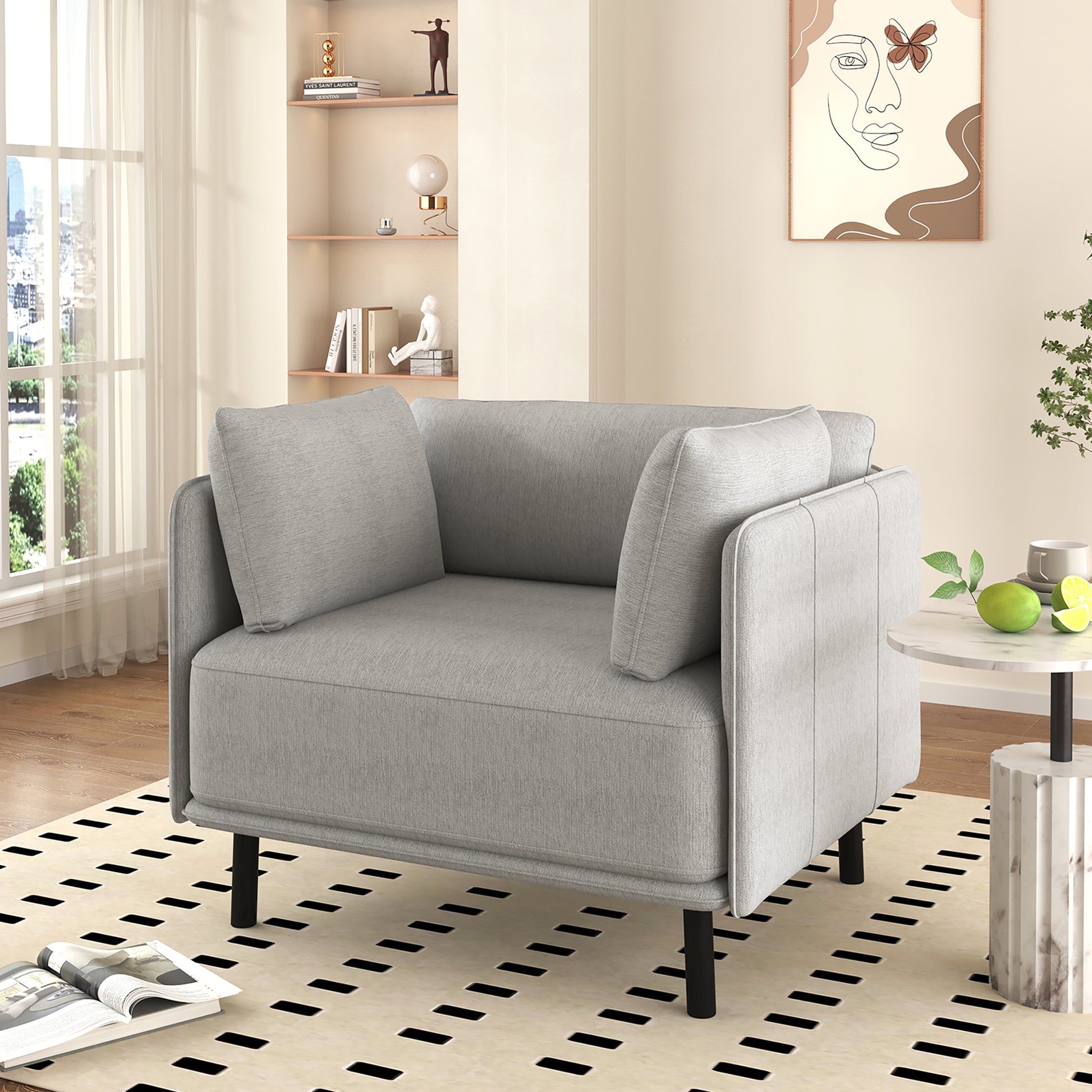 Comfortable grey armchair with plush cushions and modern black legs