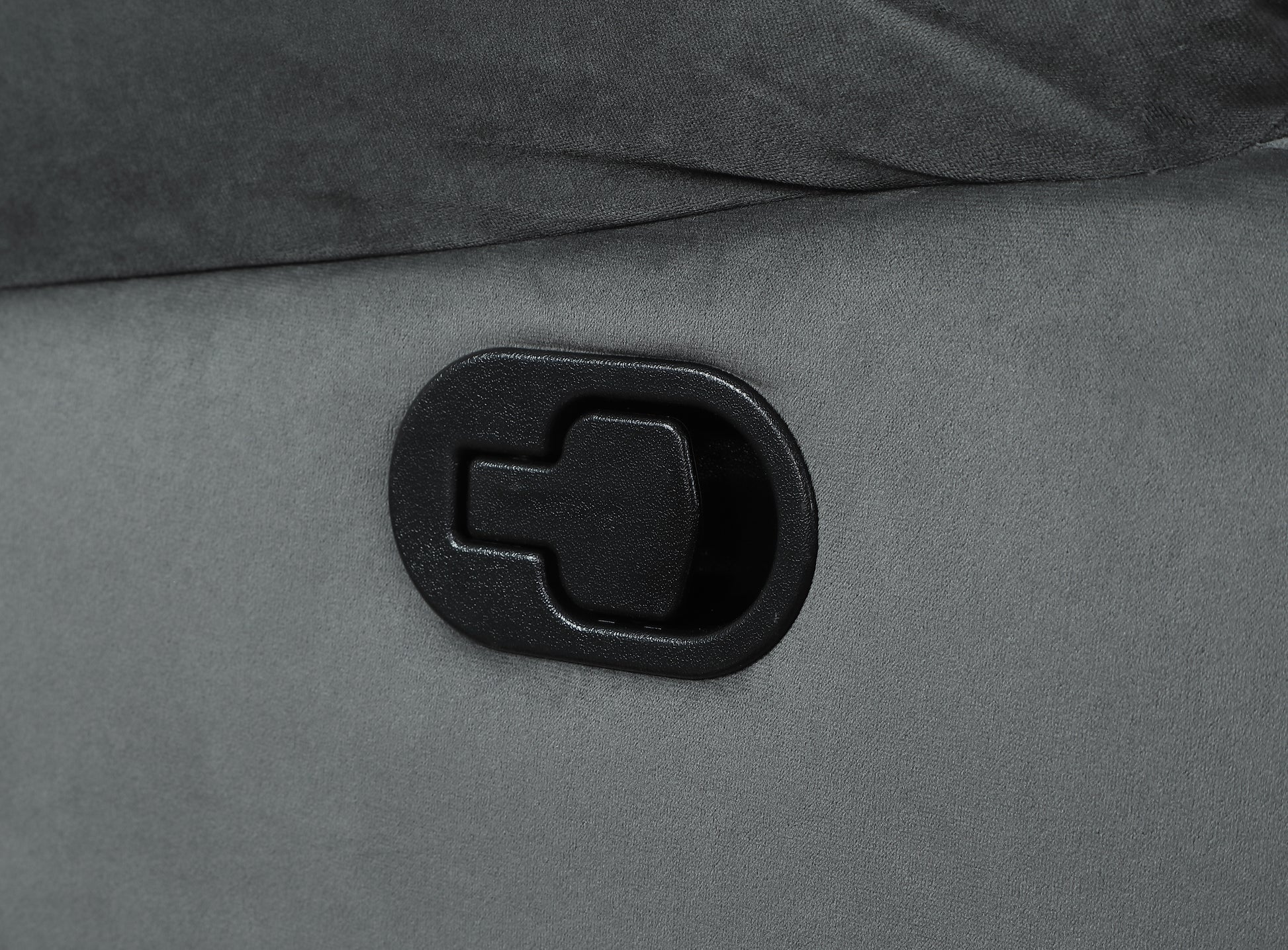 Black plastic recliner lever on grey fabric chair