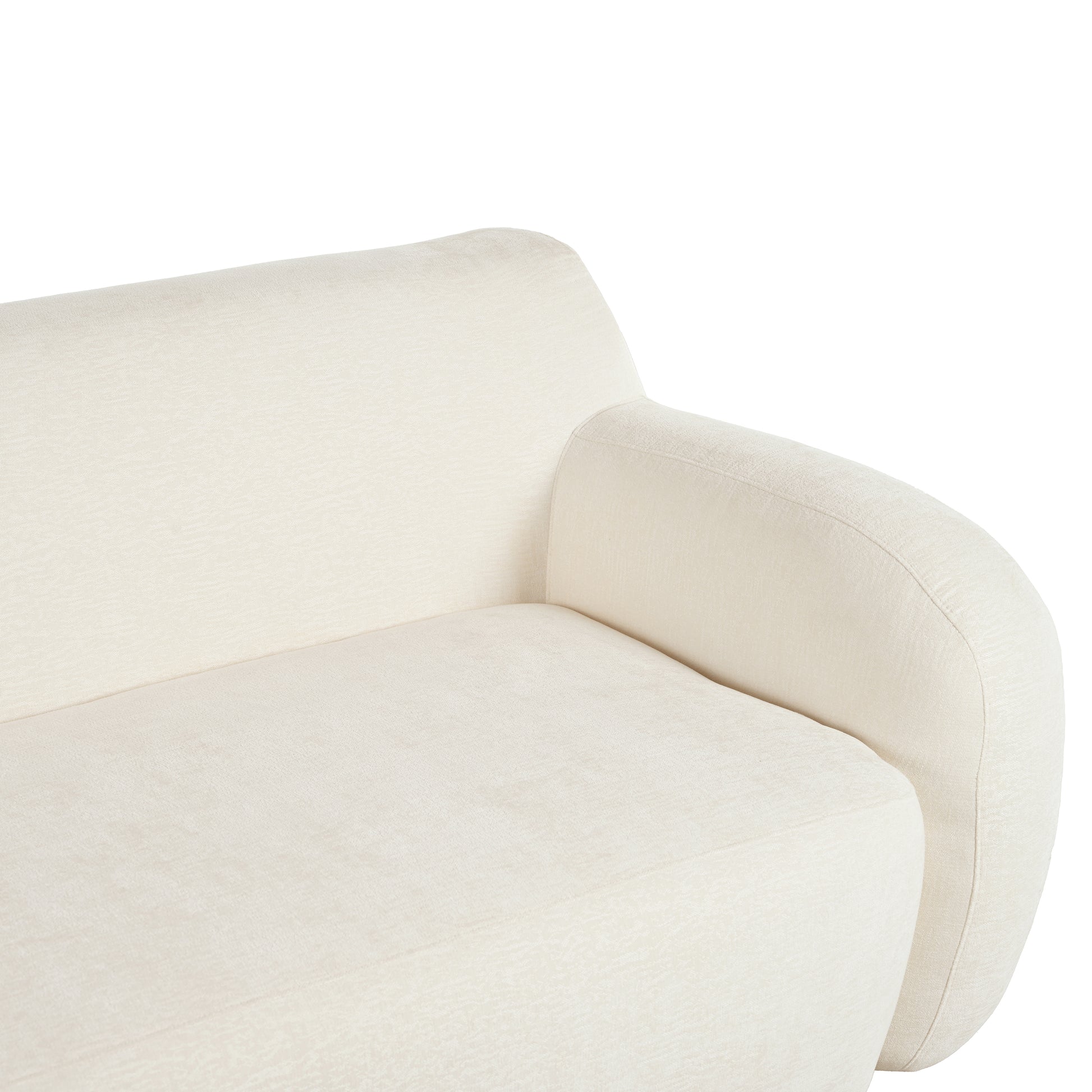 Closeup of a textured cream fabric sofa armrest and seat cushion