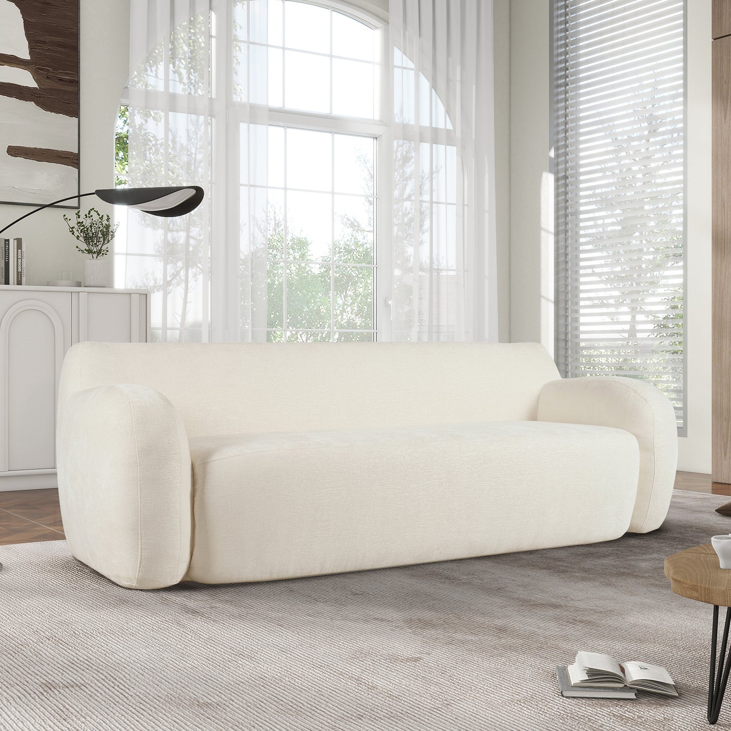Cream fabric sofa with rounded arms and plush cushioning perfect for a modern living room