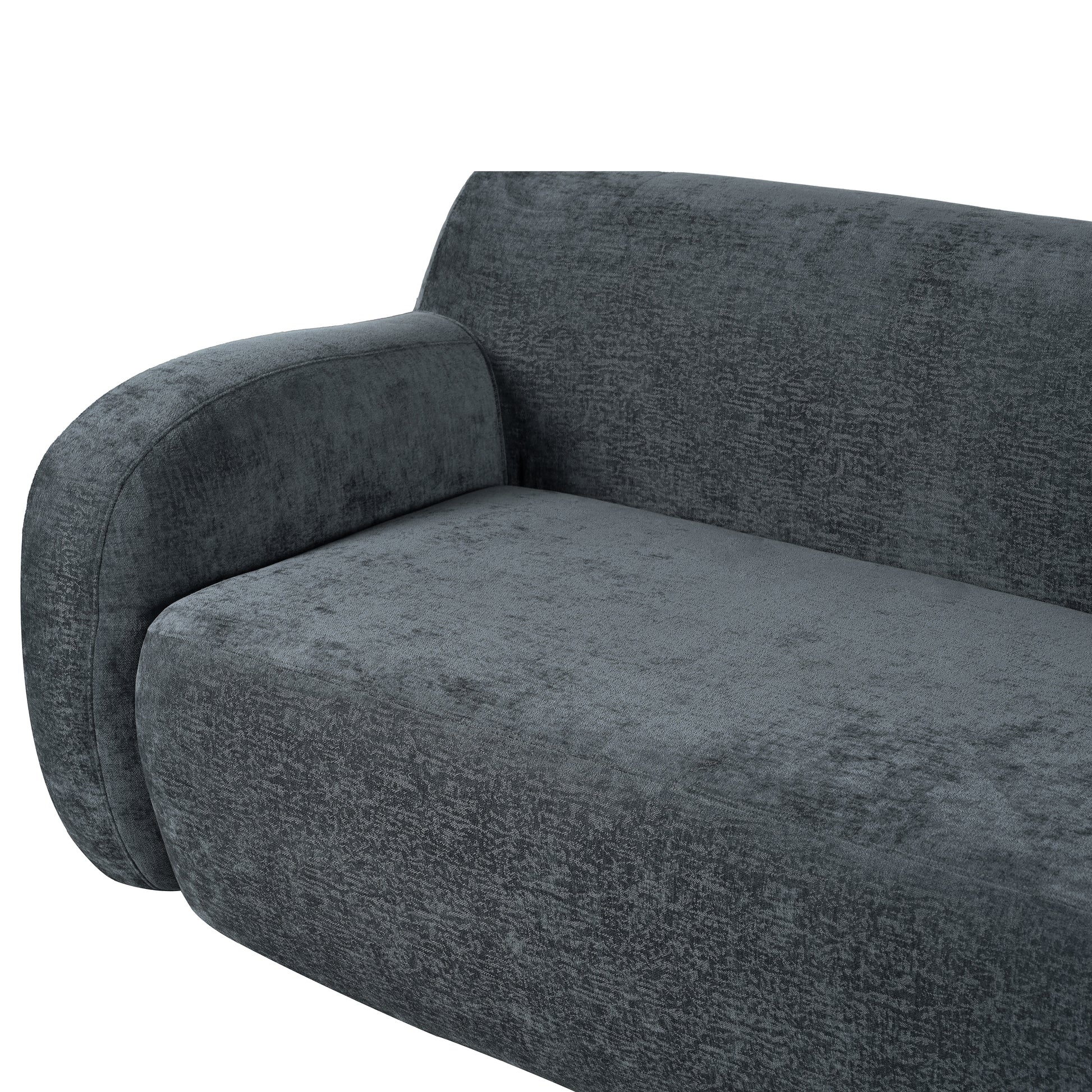 Dark grey velvet sofa with rounded armrest and textured fabric