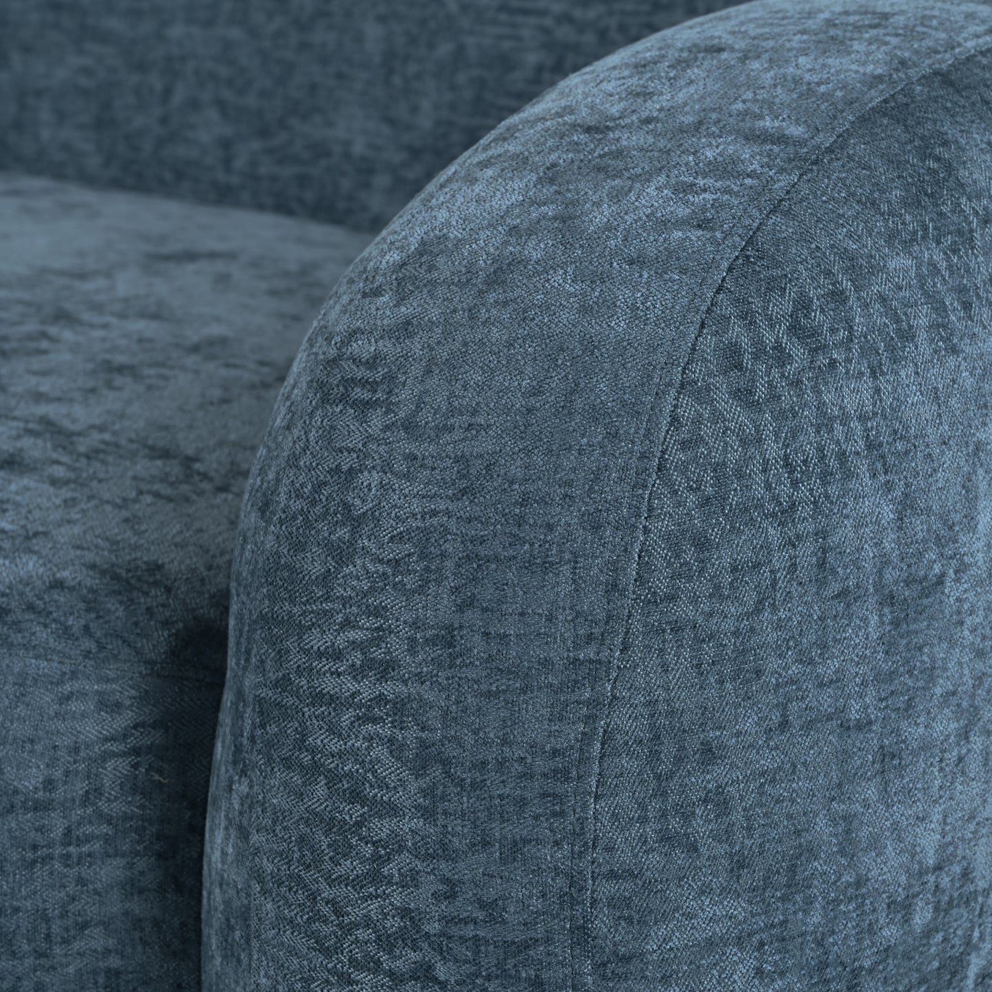 Textured blue velvet fabric detail on a modern sofa armrest