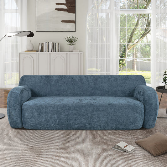 Plush blue fabric threeseater couch with rounded arms