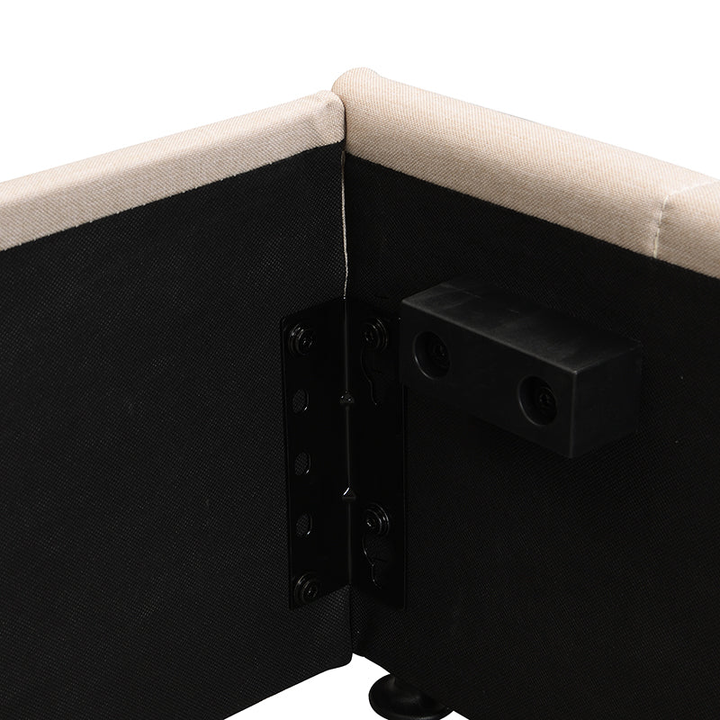 Beige upholstered bed frame corner with black metal bracket