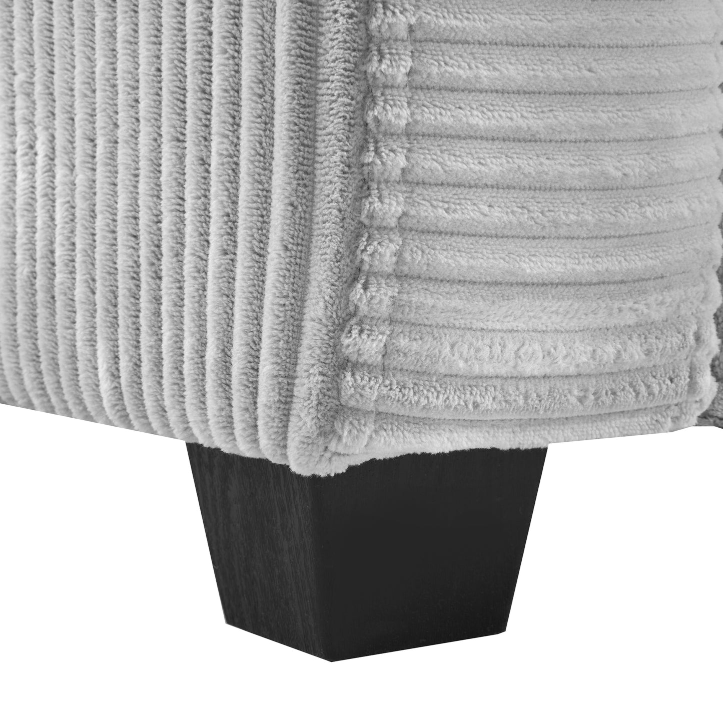 Closeup of textured grey corduroy fabric on a sofa corner