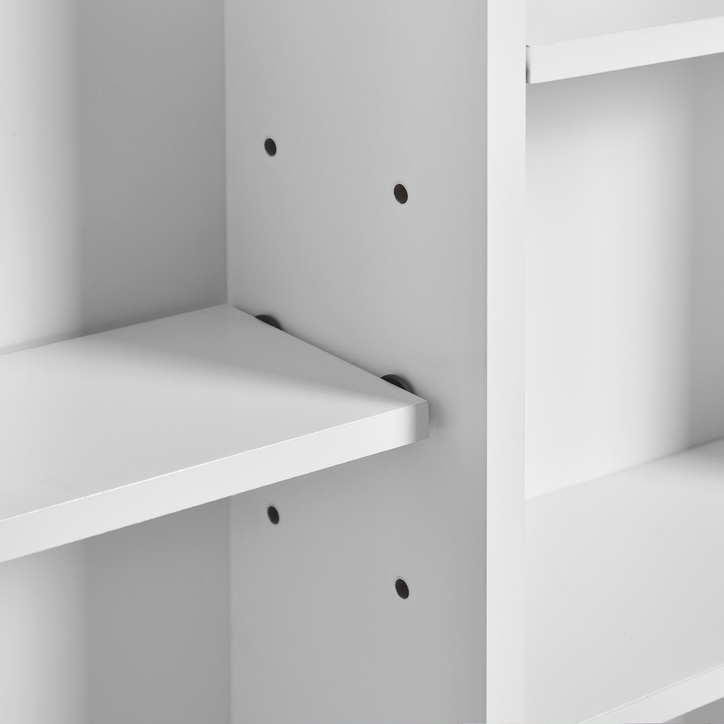 White laminate shelf detail with visible mounting holes and supports