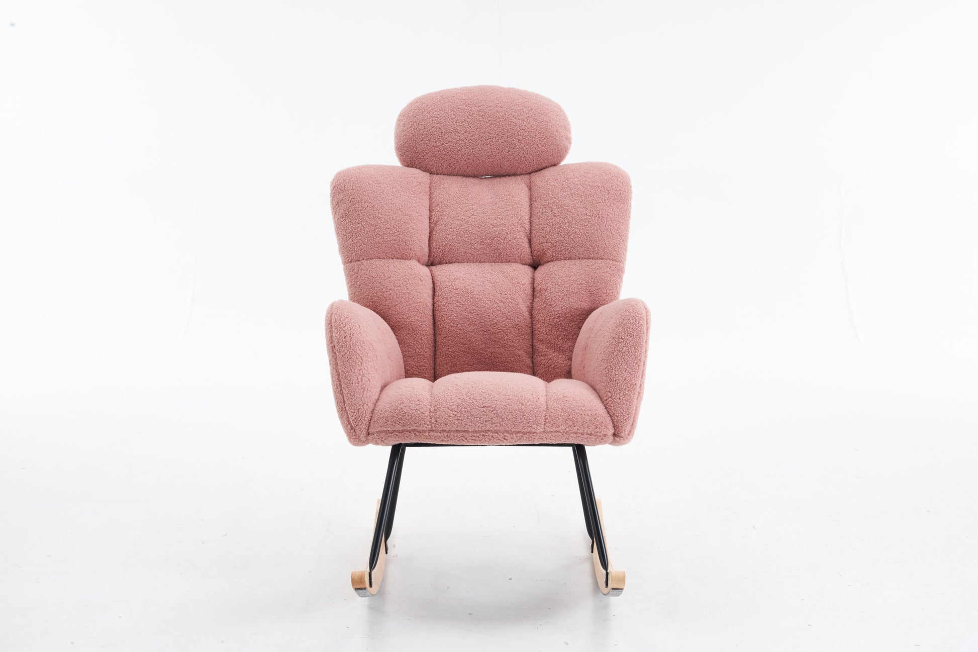 Plush pink rocking chair with tufted back and wood accents on metal legs perfect for nursery