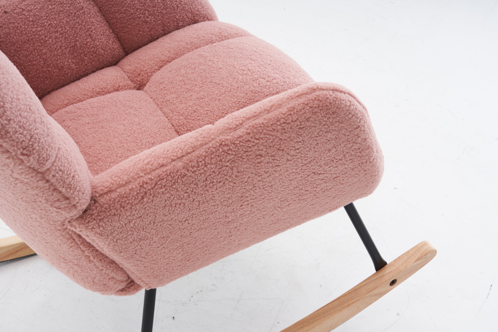Dusty rose boucle fabric armchair with tufted seat and wooden rocker base