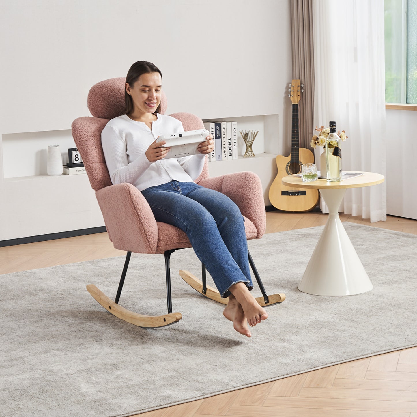 Pink boucle fabric accent chair with curved backrest and wooden rocking base